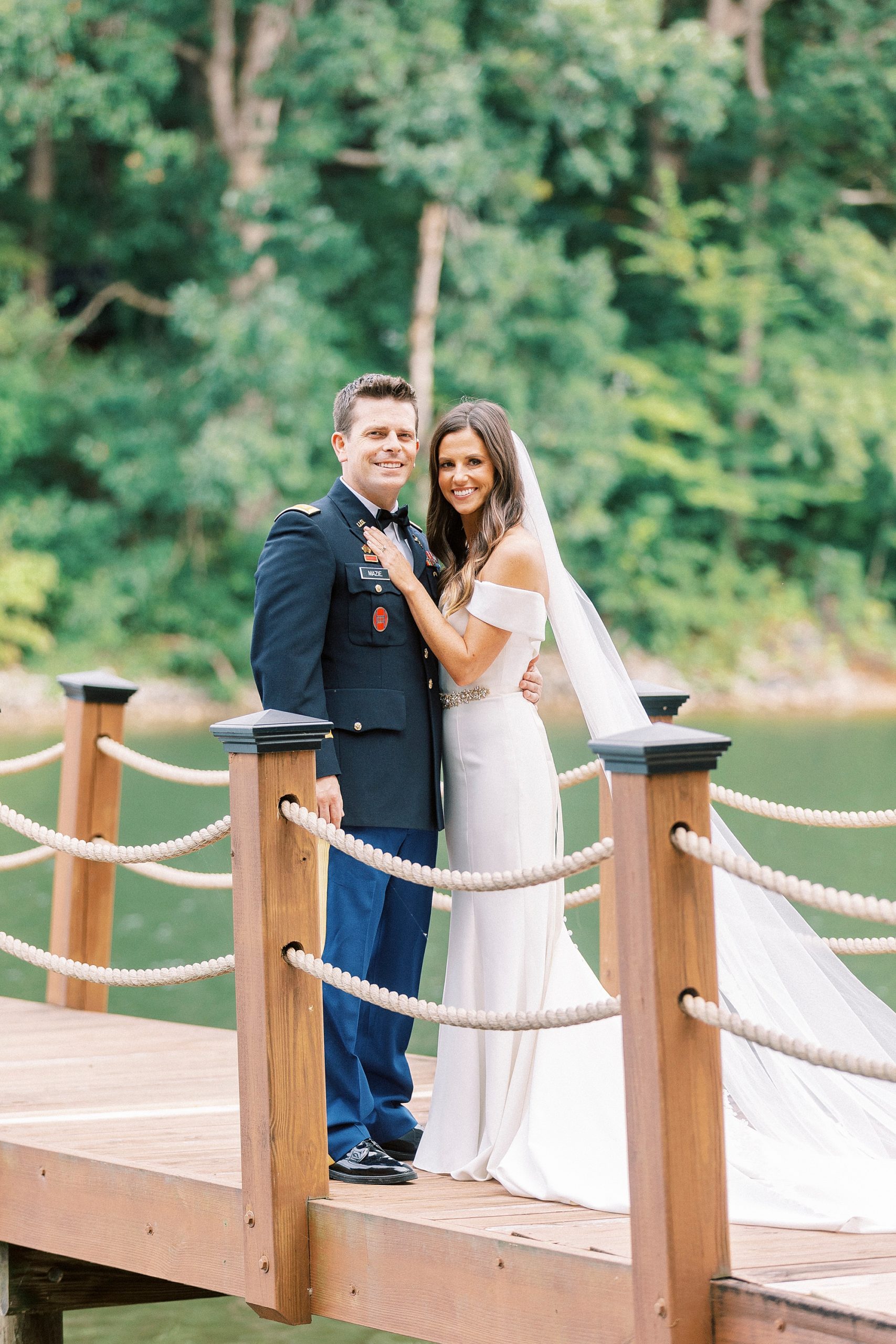 newlyweds stand on wooden dock during Lake Norman wedding portraits