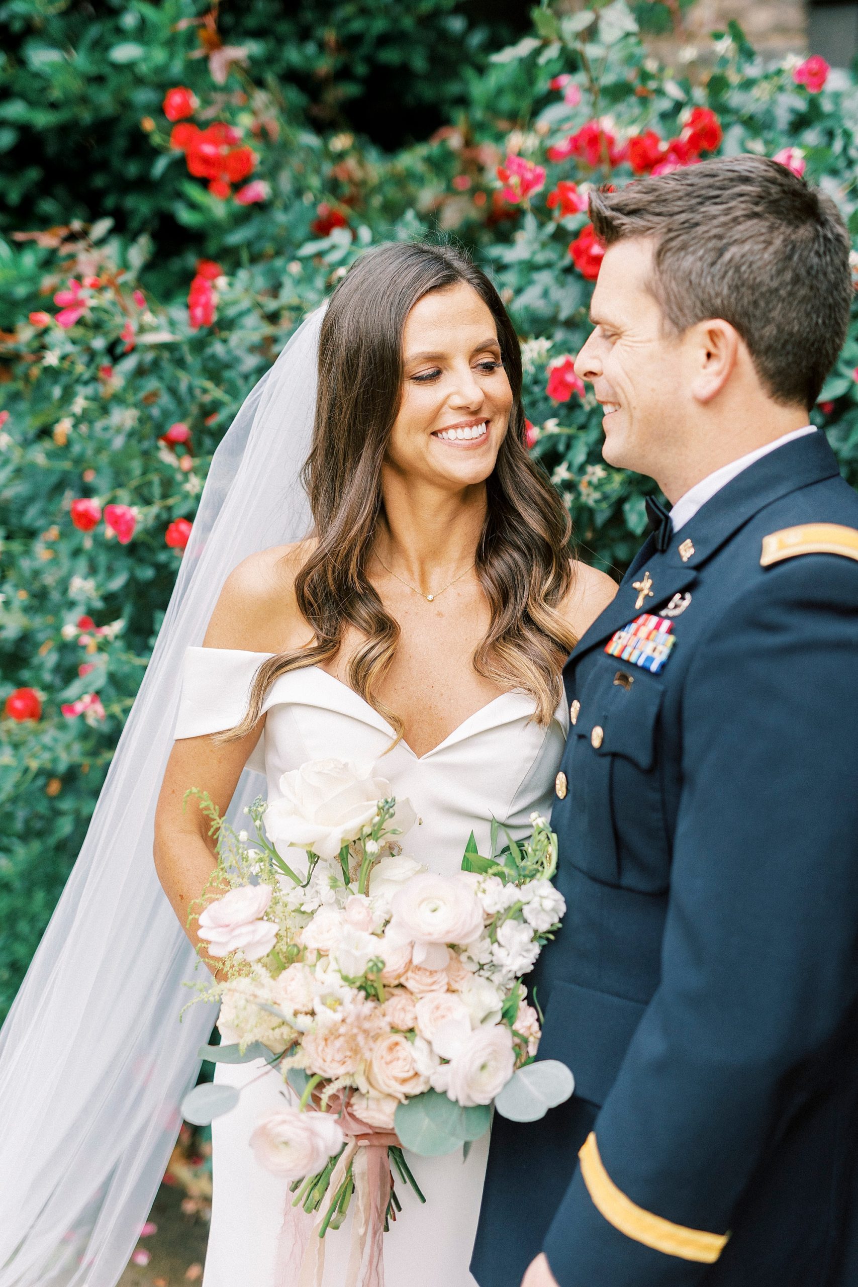bride and groom laugh together during wedding photos