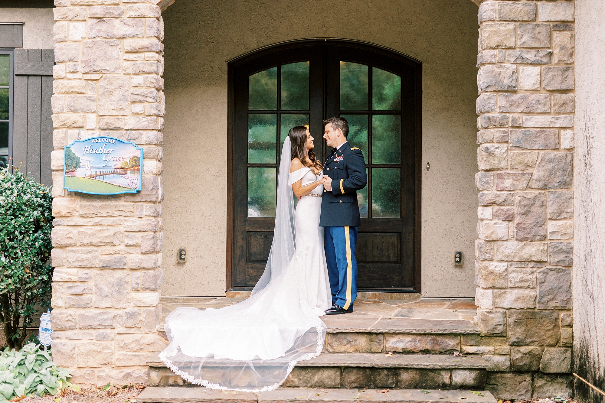 bride and groom hug on brick steps of home in Lake Norman NC