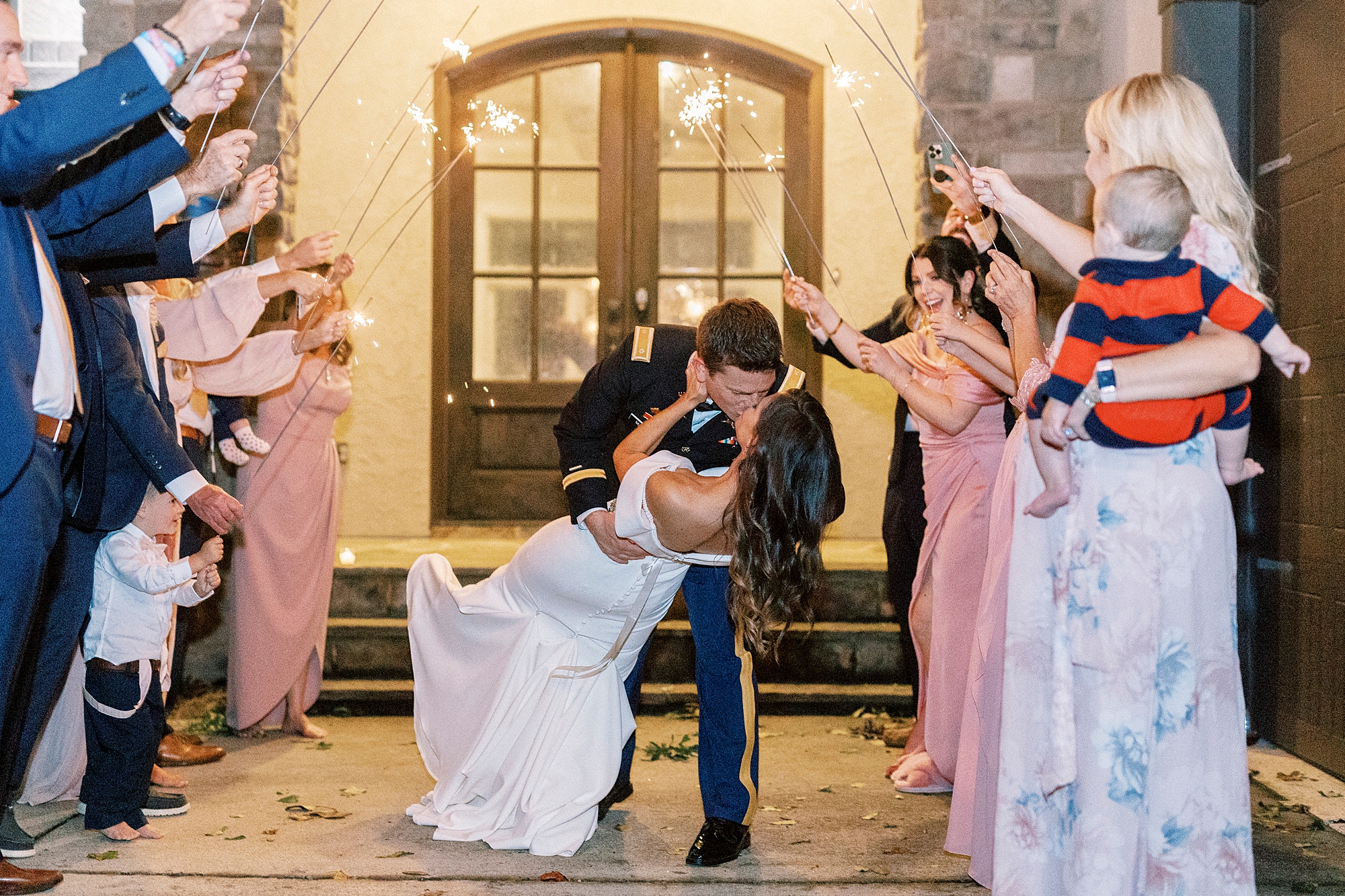 groom dips ride kissing her during sparkler exit