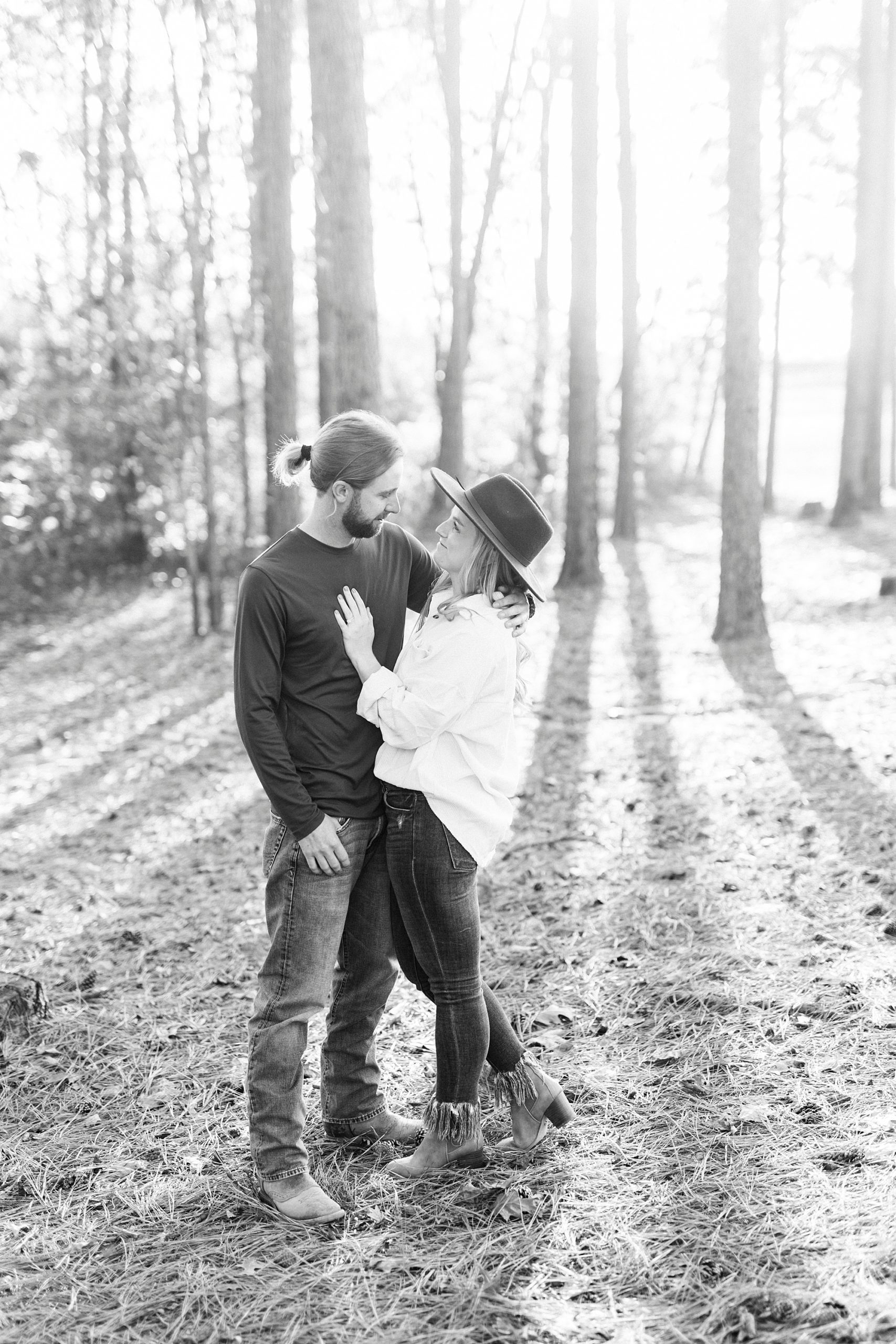 bride and groom hug during portraits in the woods at sunset