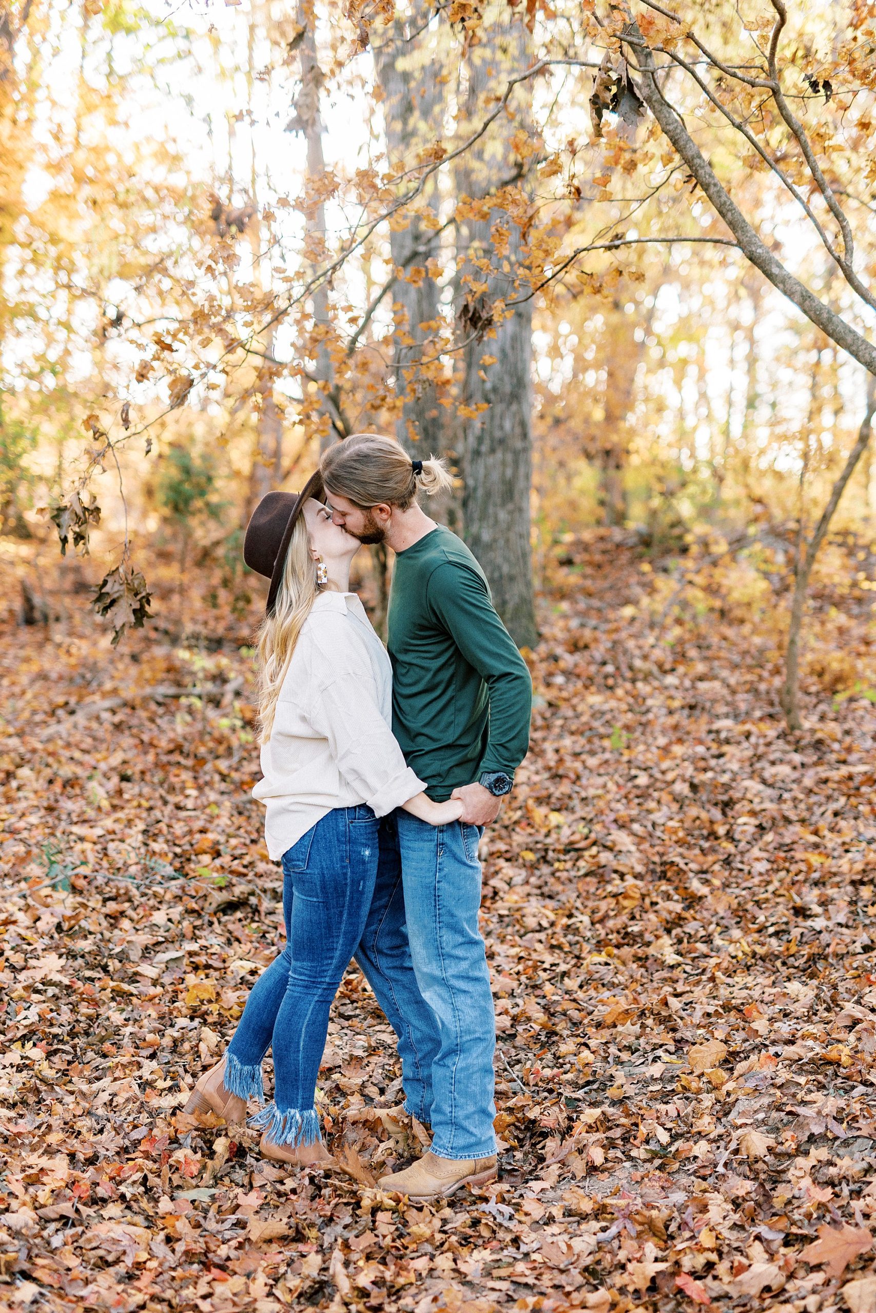 bride and groom kiss during chic fall engagement session
