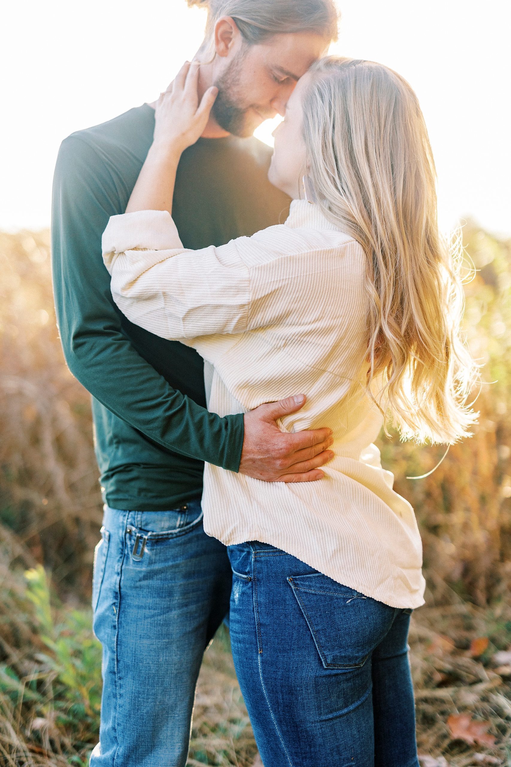 bride and groom hug at sunset in field near Richfield NC home