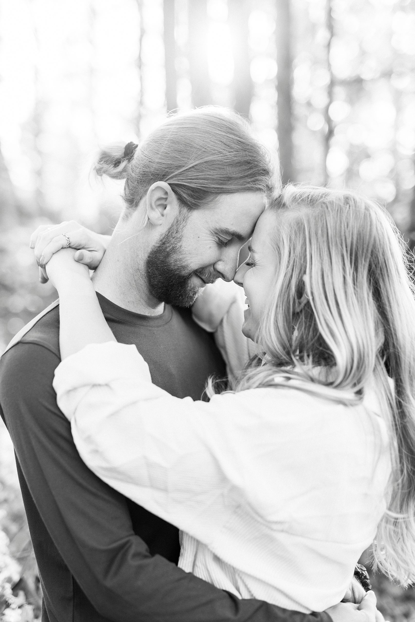 bride and groom hug leaning heads together in NC