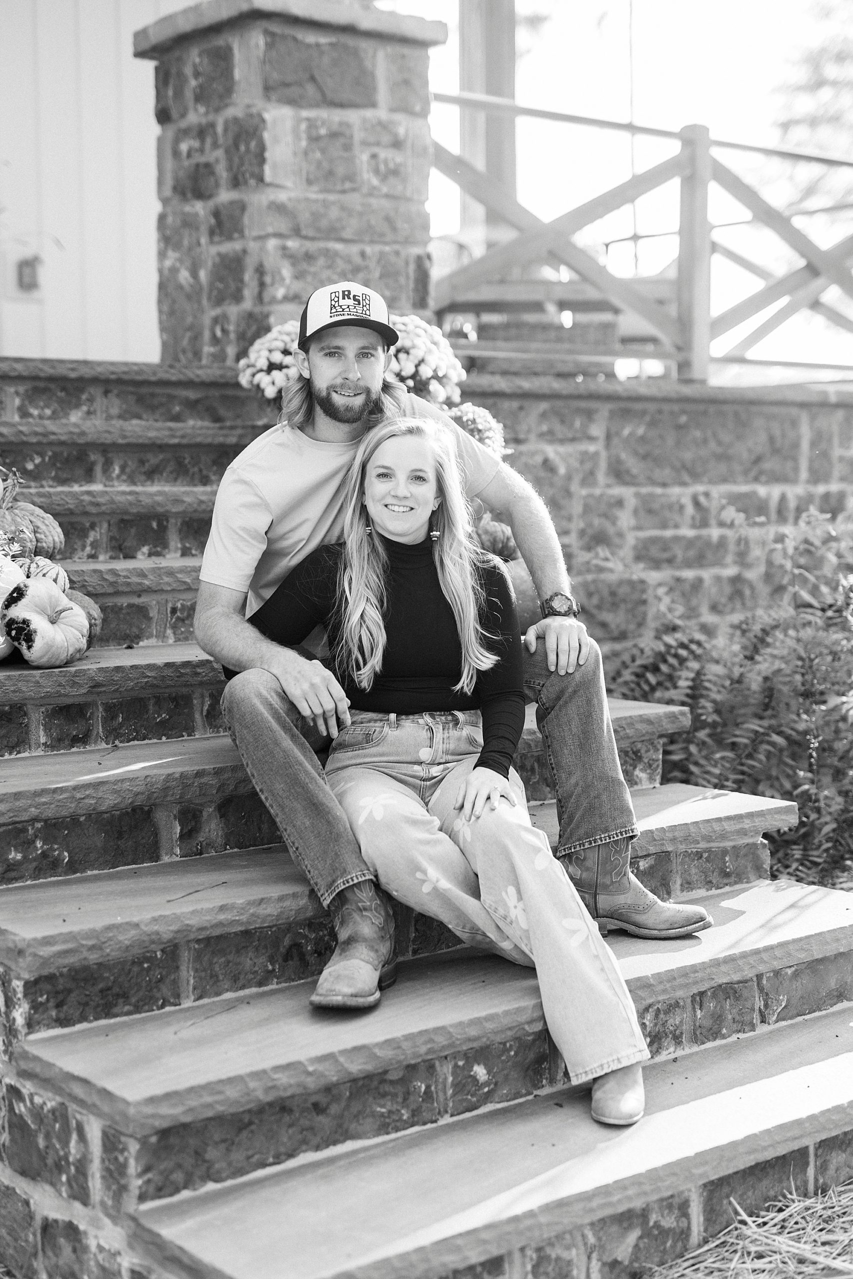 bride and groom sit on front steps of custom home in Richfield NC