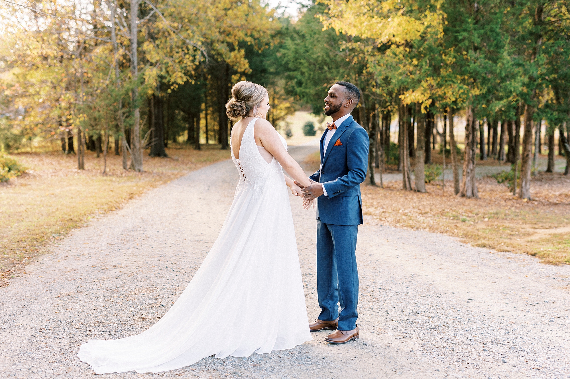 bride and groom hold hands on walkway at Bella Terra 