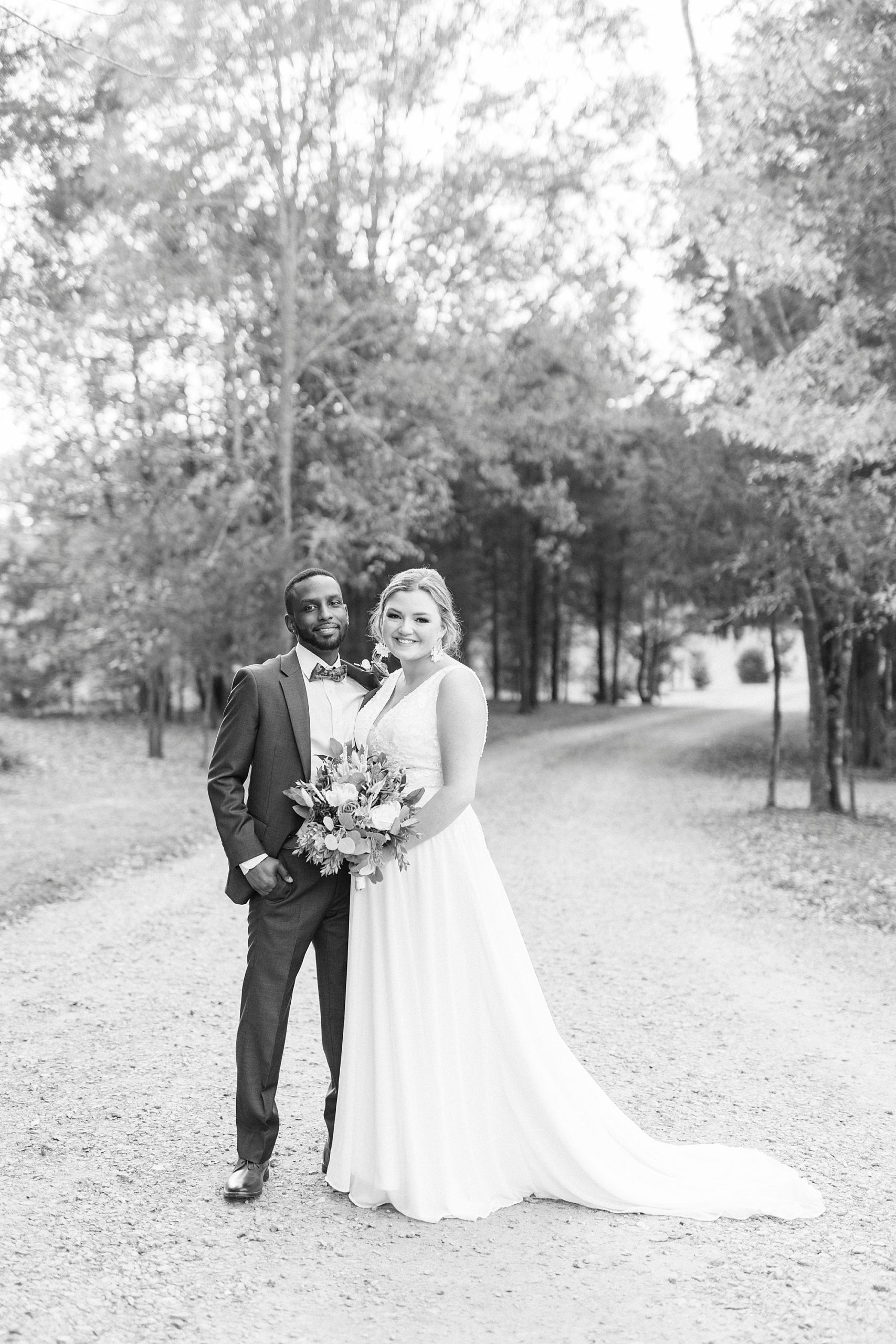 bride and groom hug on driveway at Bella Terra 