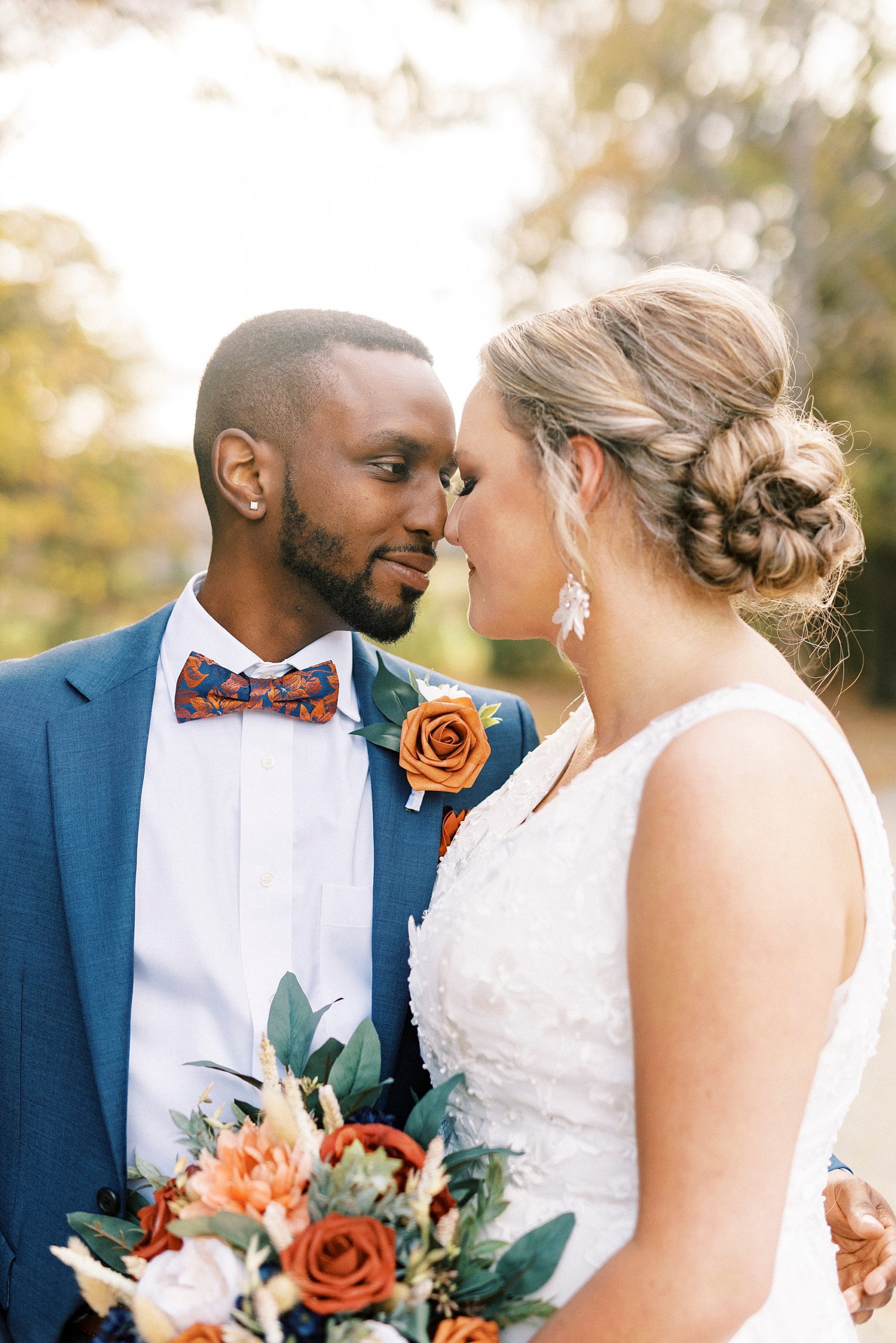 bride and groom touch noses on wedding day