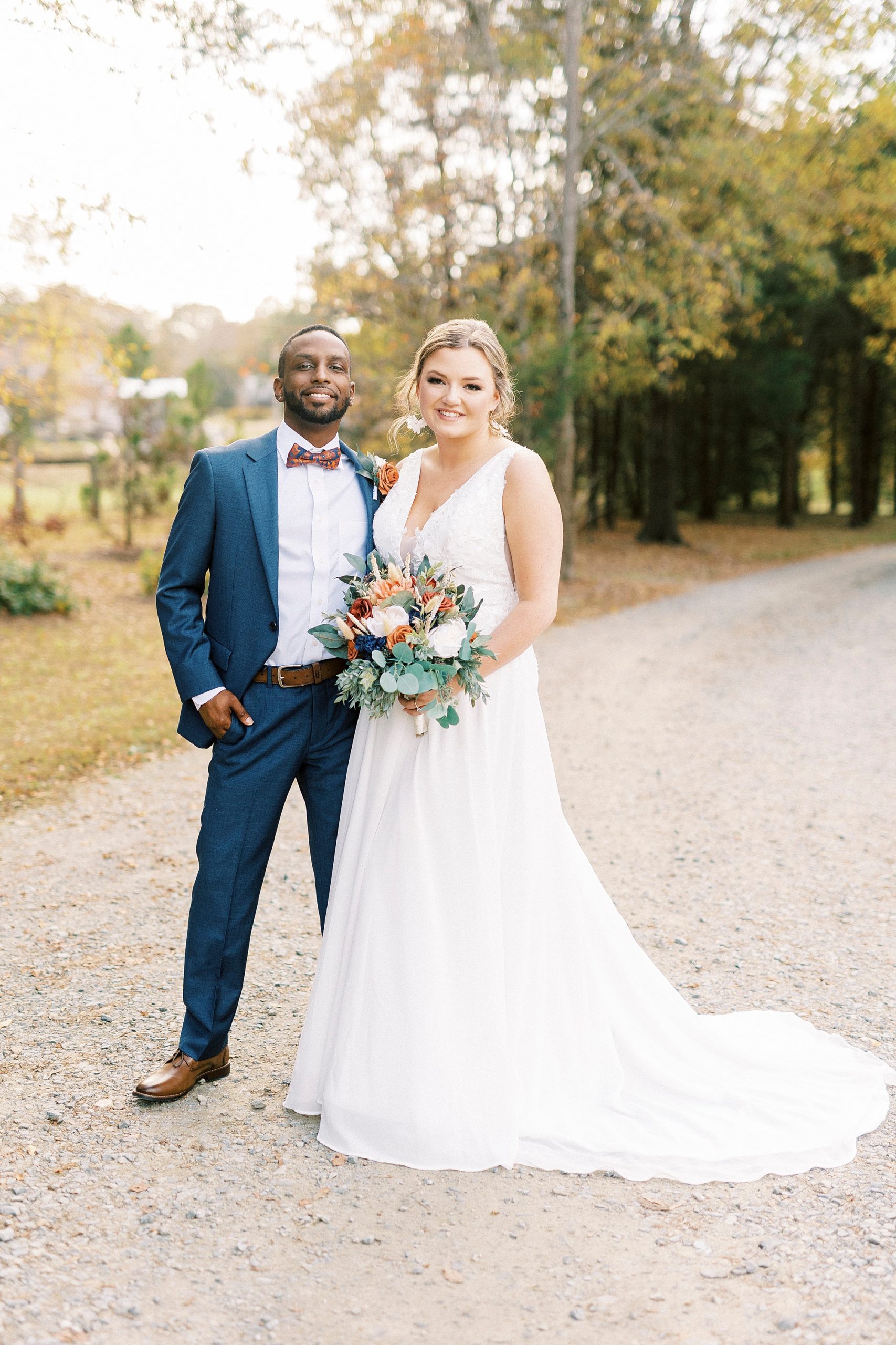 bride and groom stand together on driveway at Bella Terra 