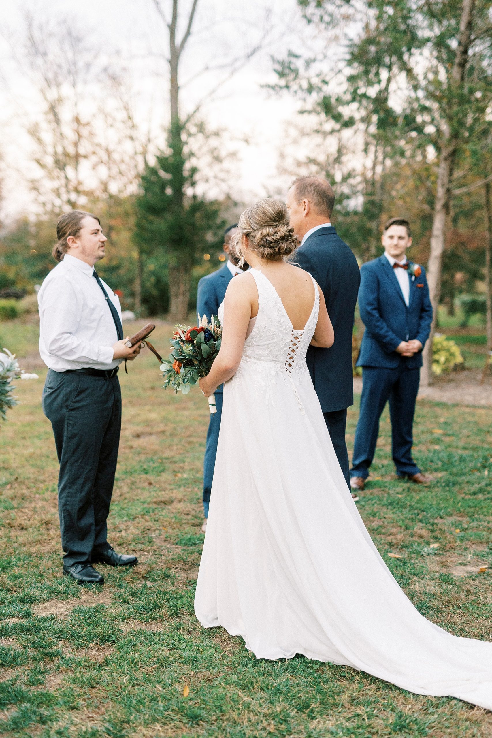 bride and father approach groom and officiant during outdoor wedding ceremony in Indian Trail, NC