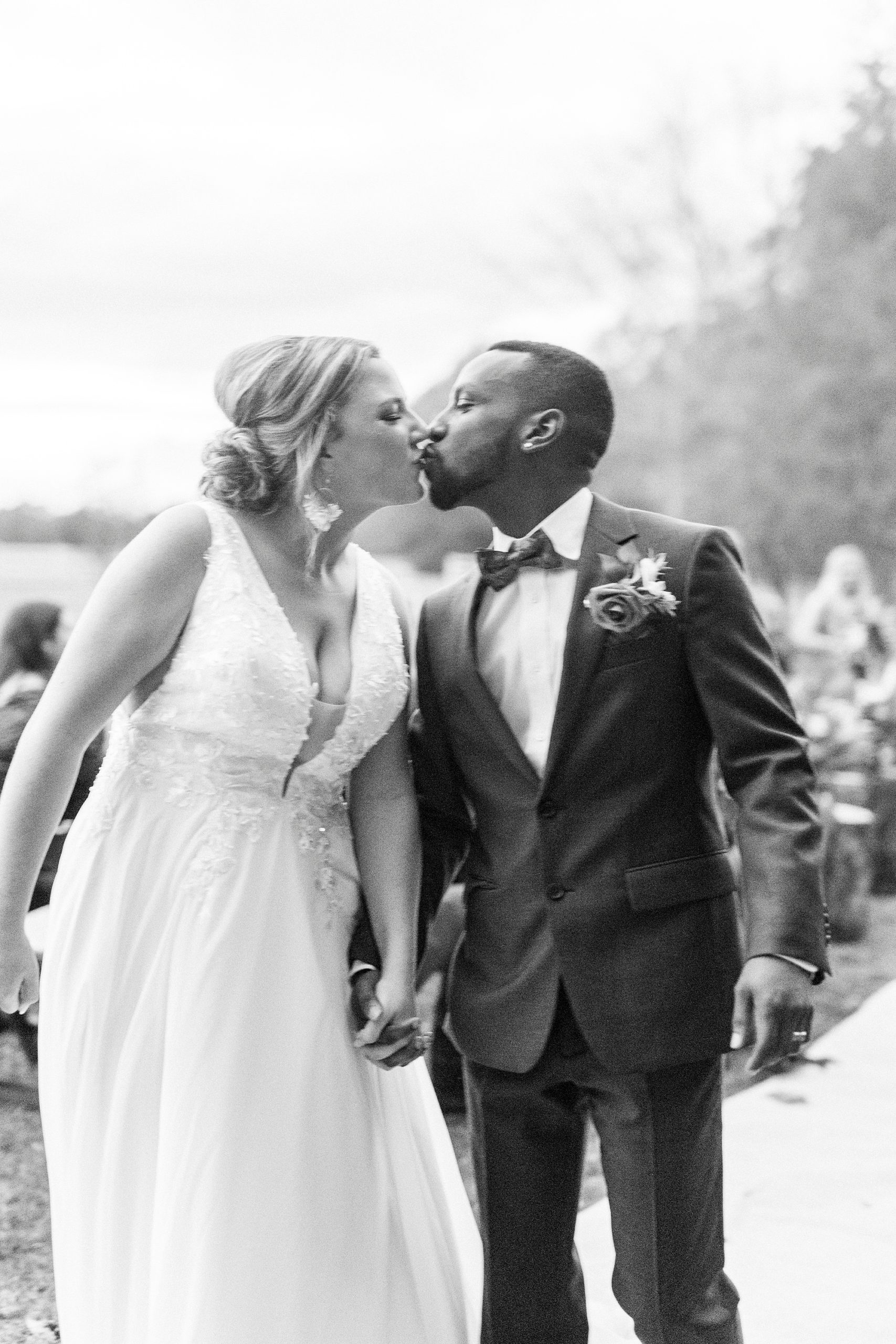 bride and groom kiss walking up aisle after outdoor wedding ceremony in Indian Trail, NC