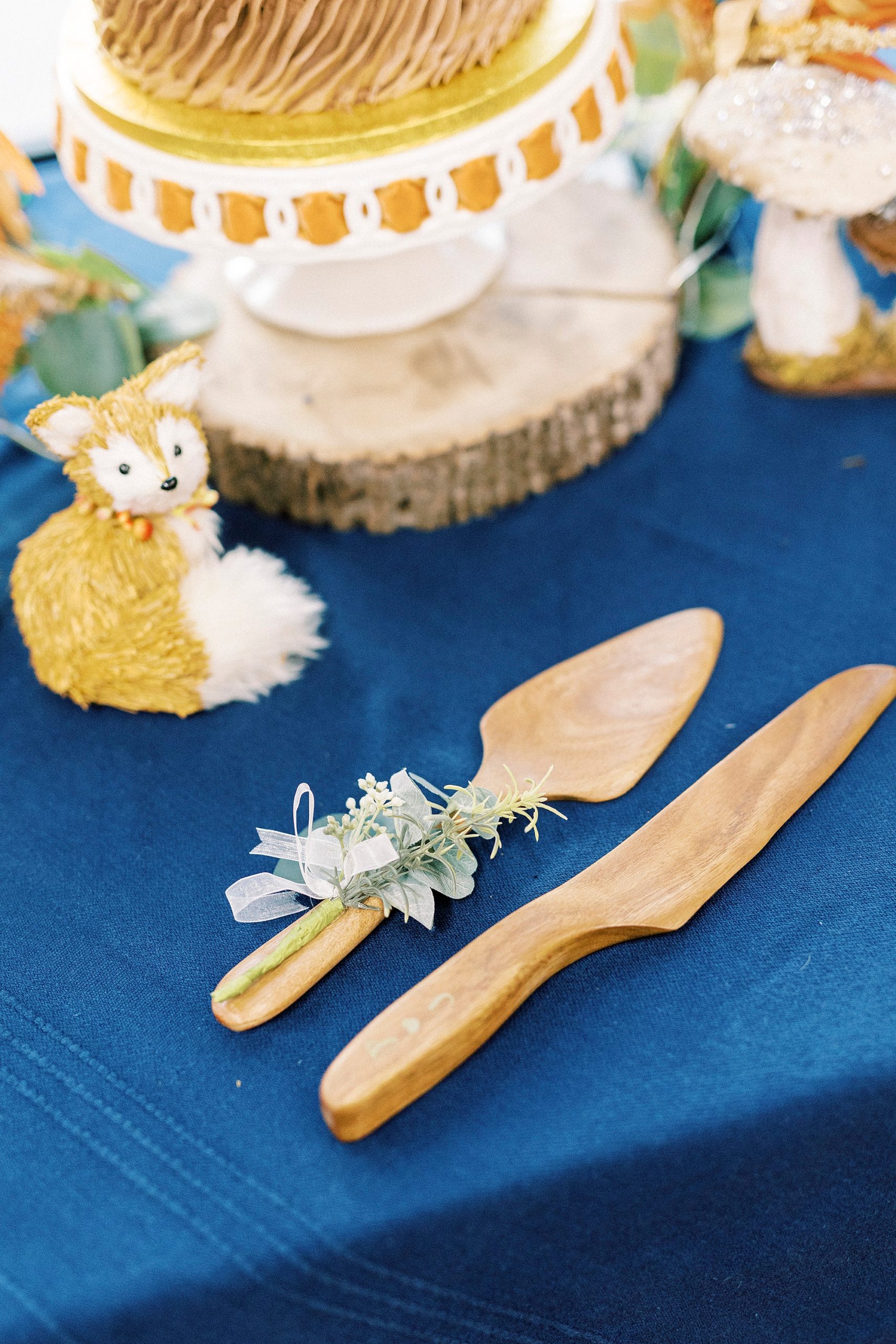 wooden cake cutting knife and fox on table at Bella Terra Inc.
