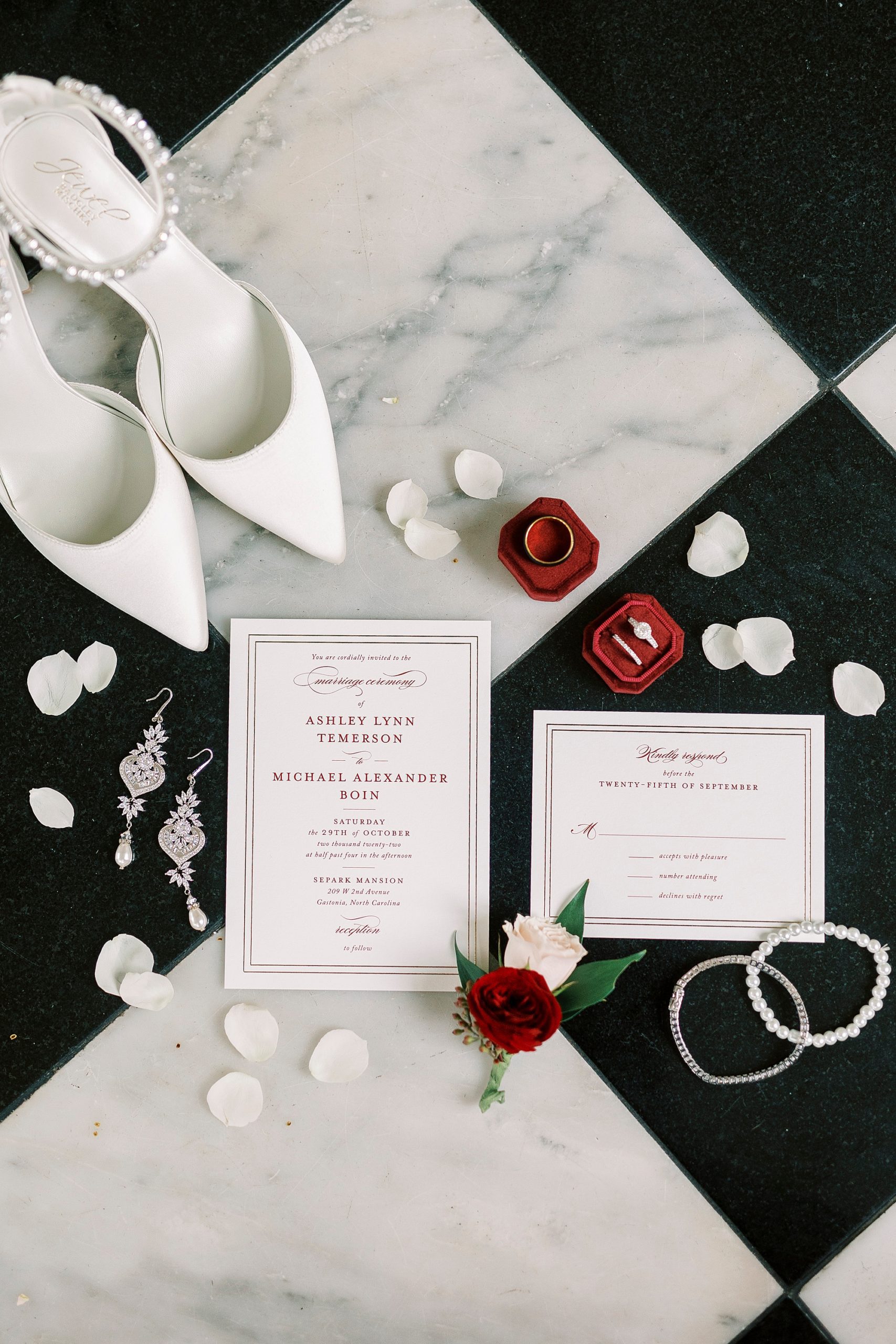 bride's white shoes and invitation suite on black and white floor at Separk Mansion