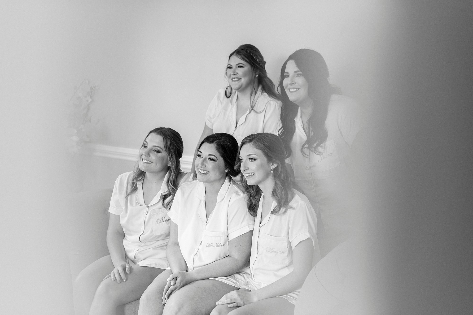 bride and bridesmaids smile sitting together before fall wedding at Separk Mansion