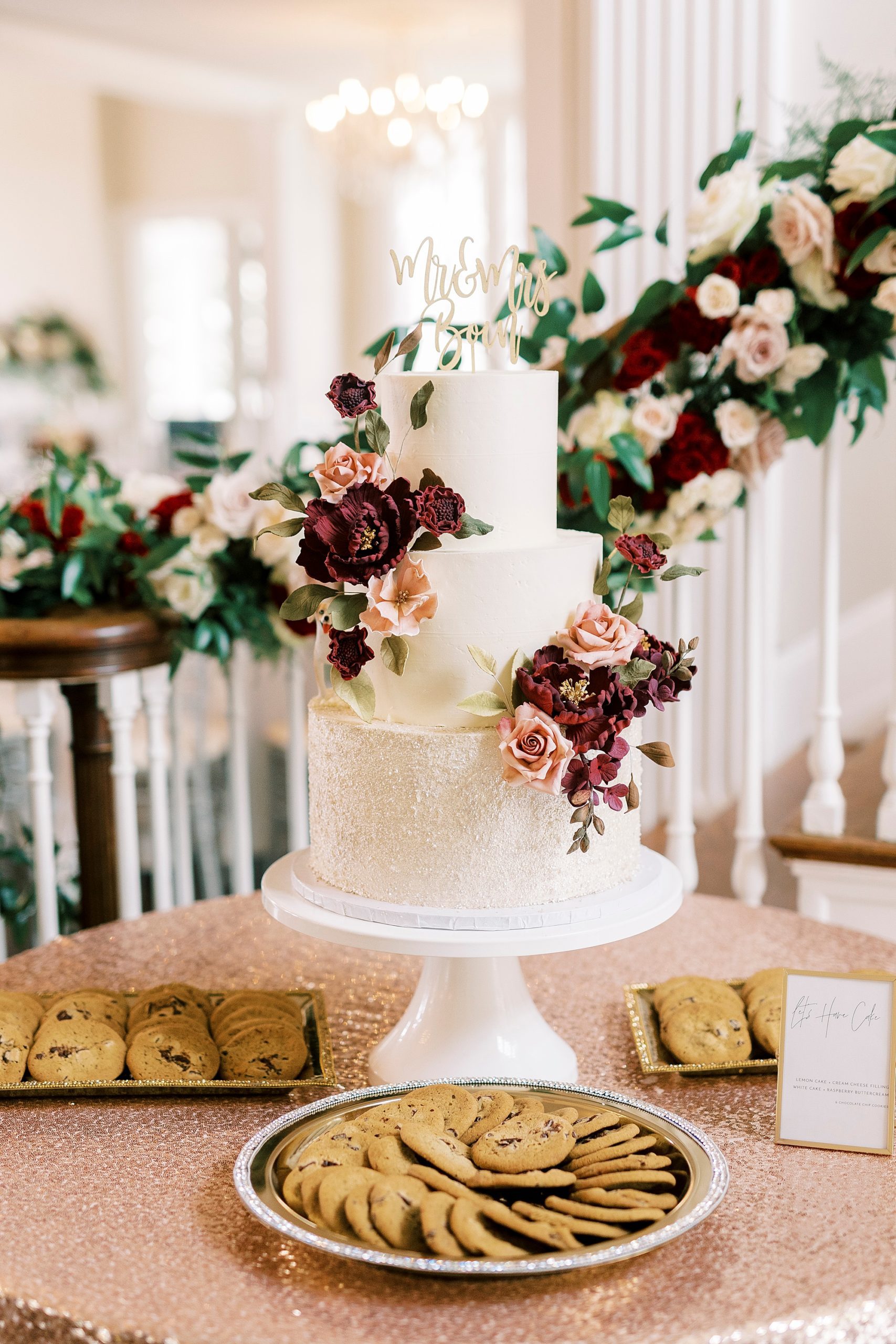 wedding cake for fall reception with pink and red flower accents