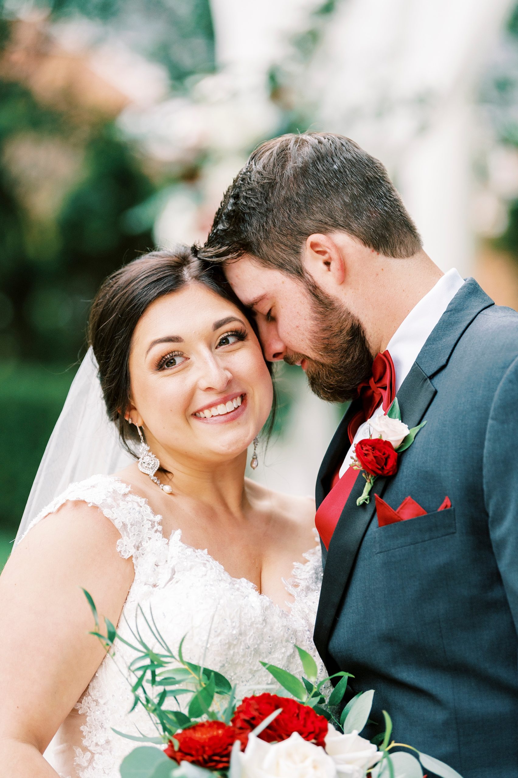 groom leans head into bride's forehead
