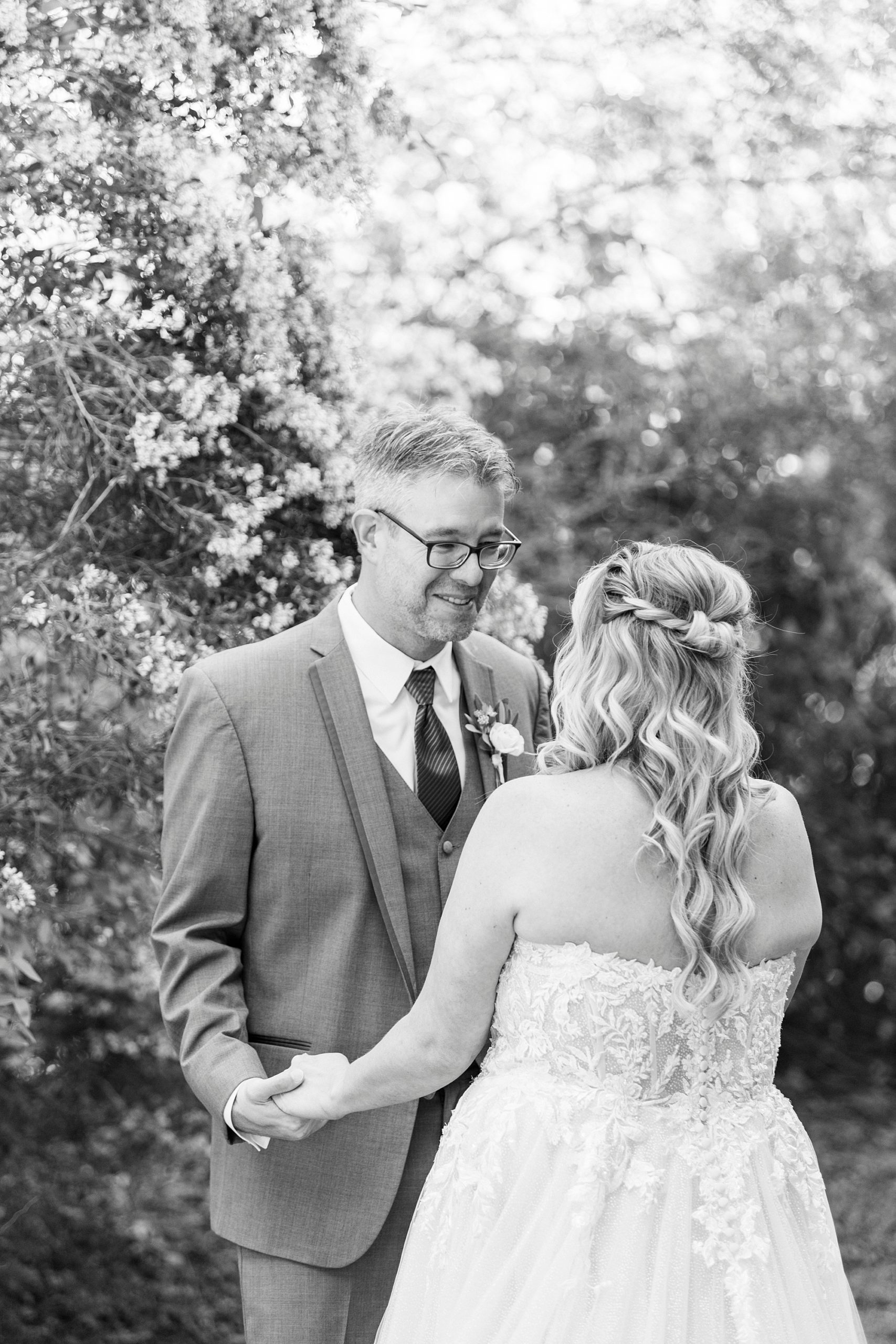 bride and groom smile during first look at the Gin at Aw Shucks Farm