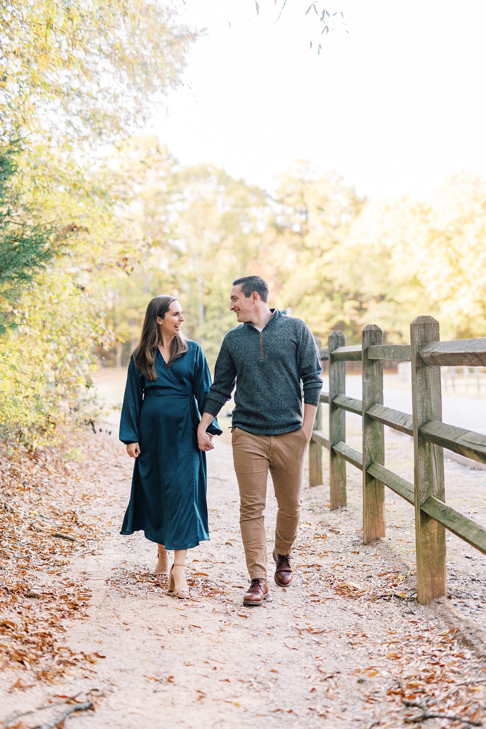 bride and groom hold hands walking through Latta Nature Preserve