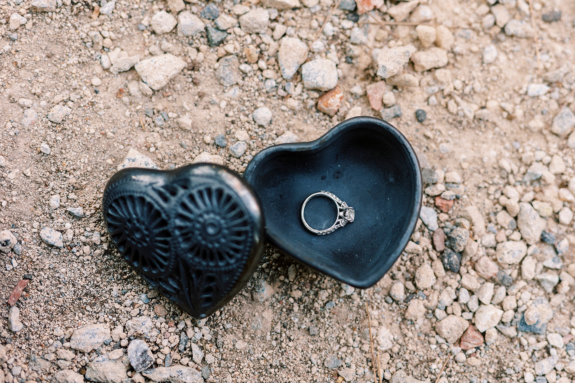 diamond ring rests in black ring box