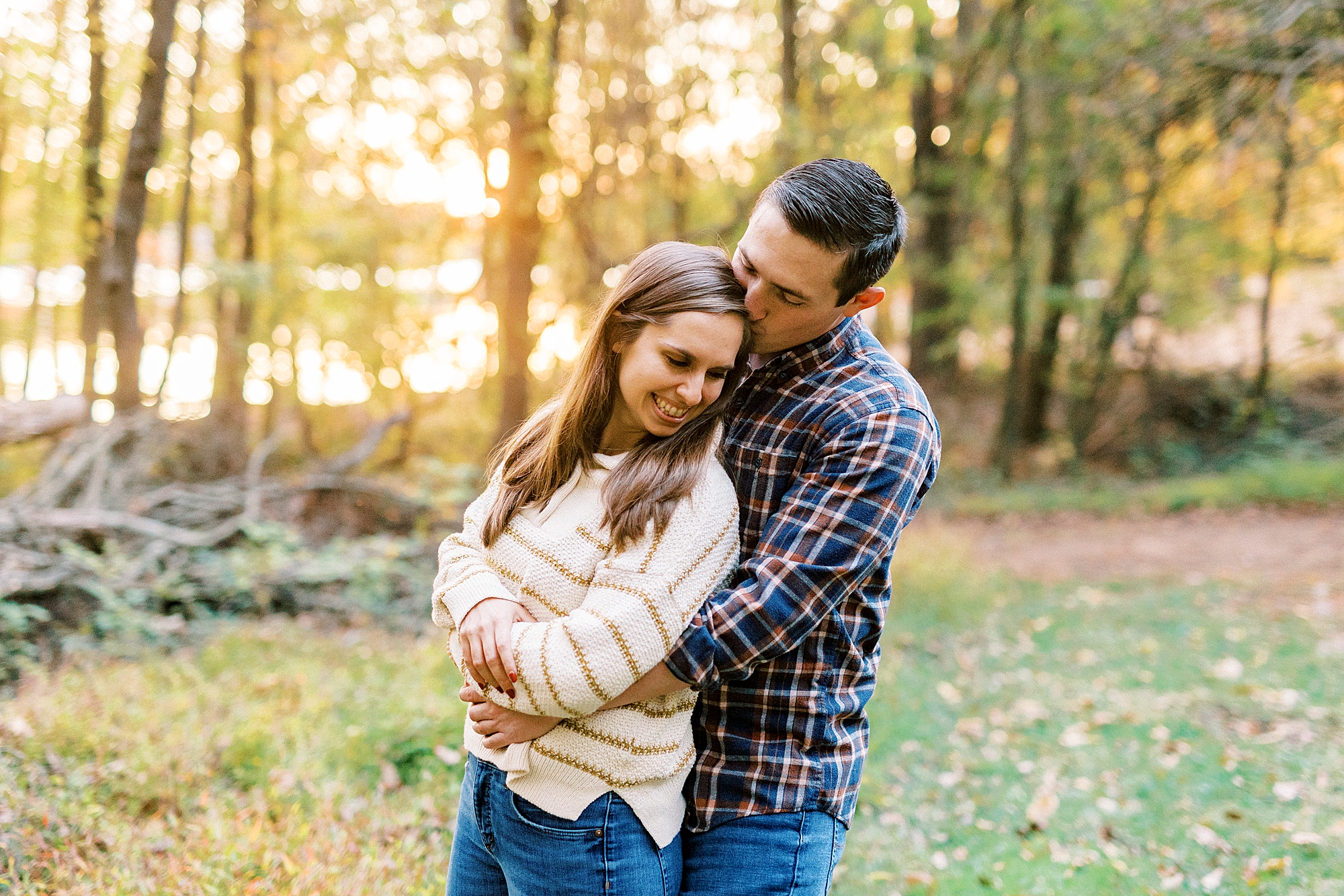 bride and groom hug together during portraits at sunset