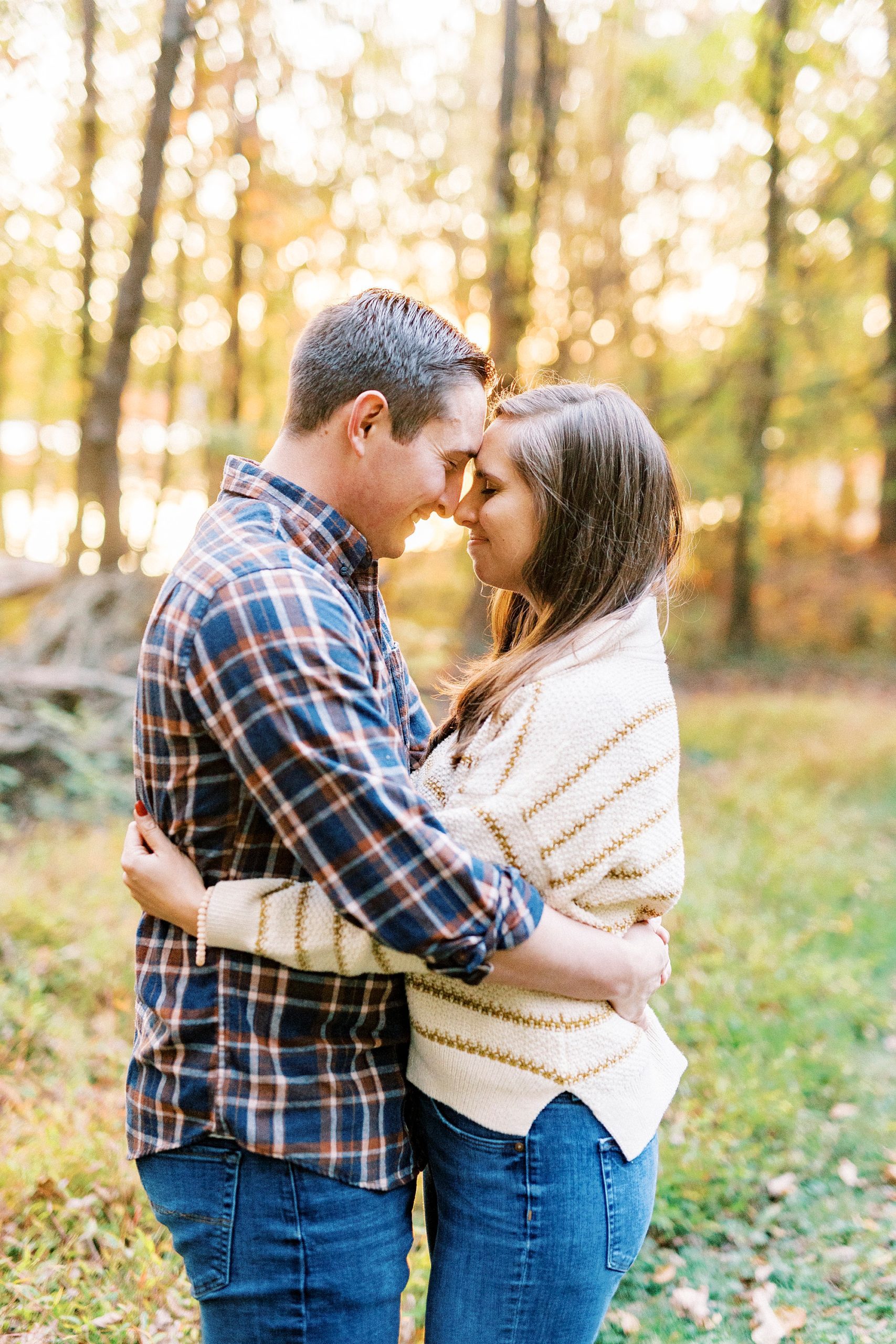 engaged couple hugs leaning foreheads together at Latta Nature Preserve