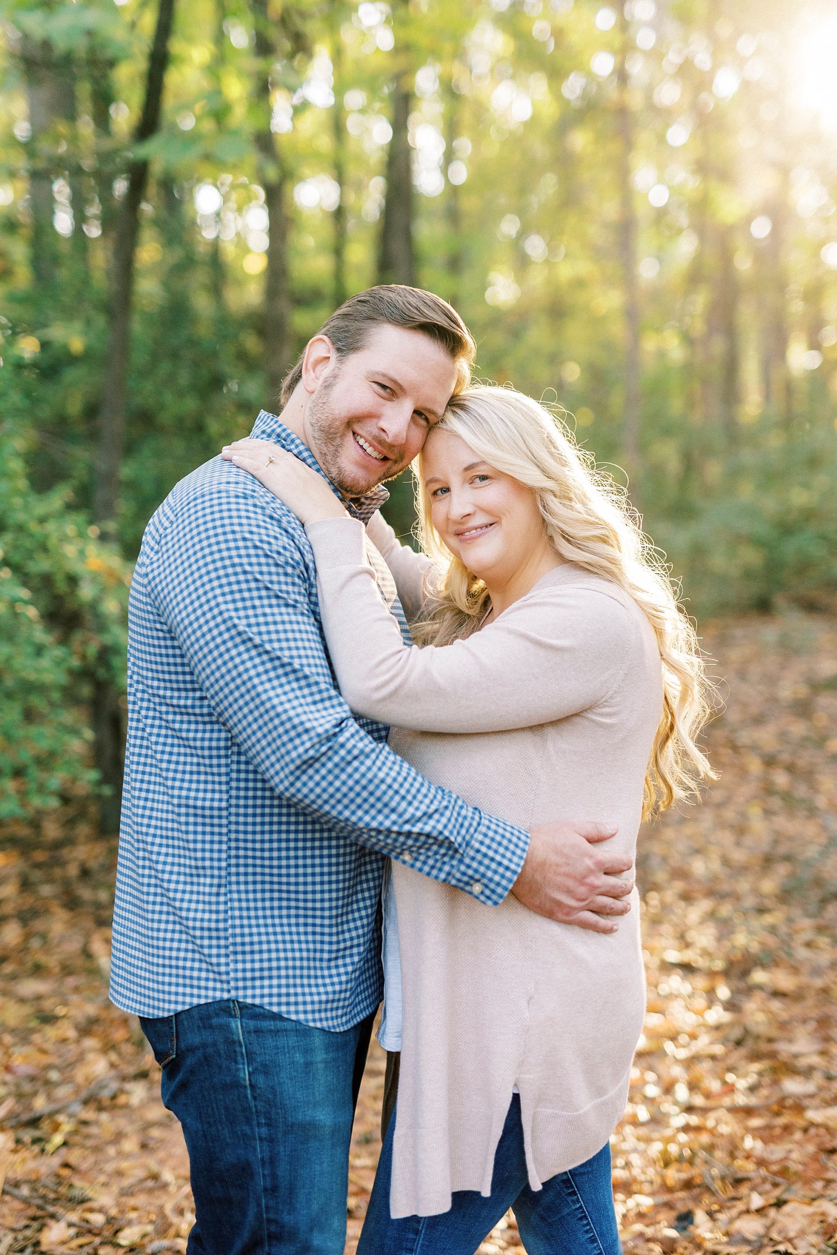 bride and groom hug leaning heads together at Latta Nature Preserve