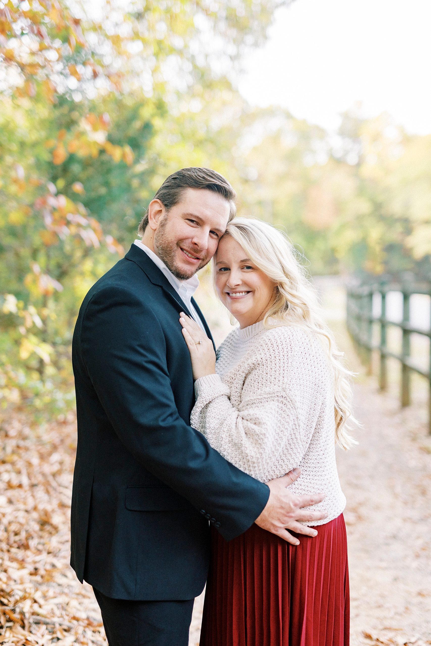 couple hugs by wooden fence in NC