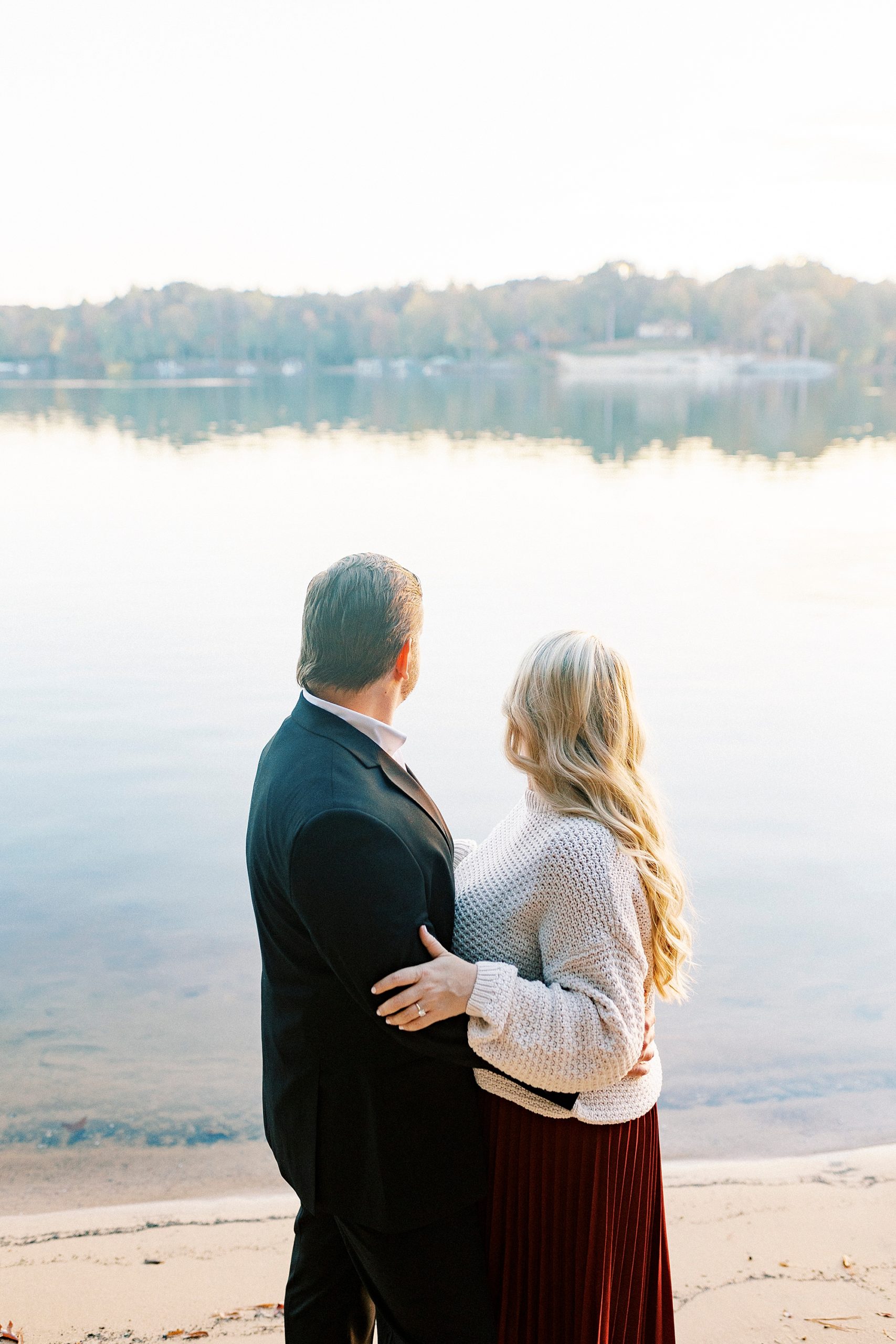 engaged couple looks out over water at Latta Nature Preserve