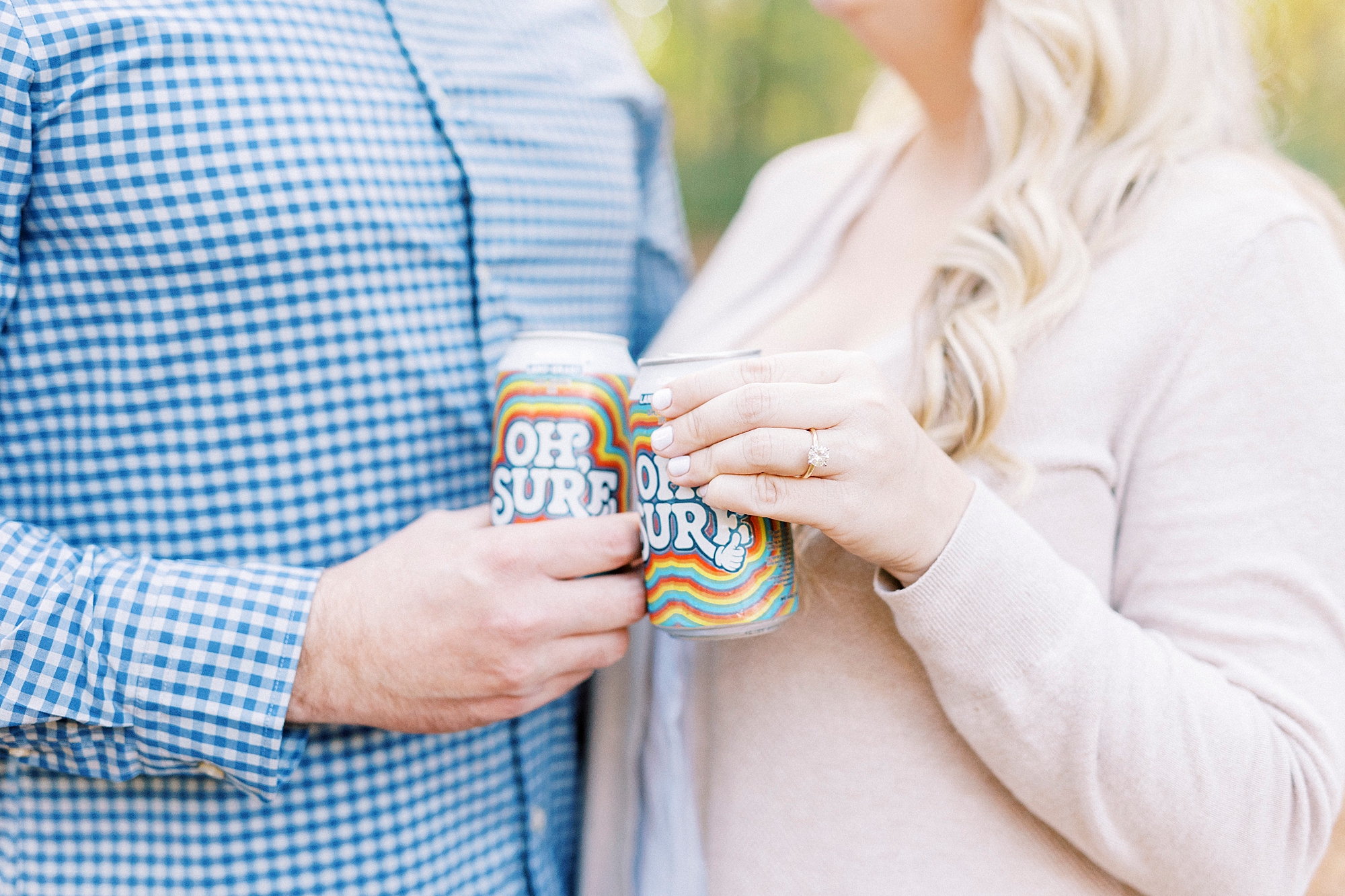 engaged couple toasts drinks during fall engagement photos