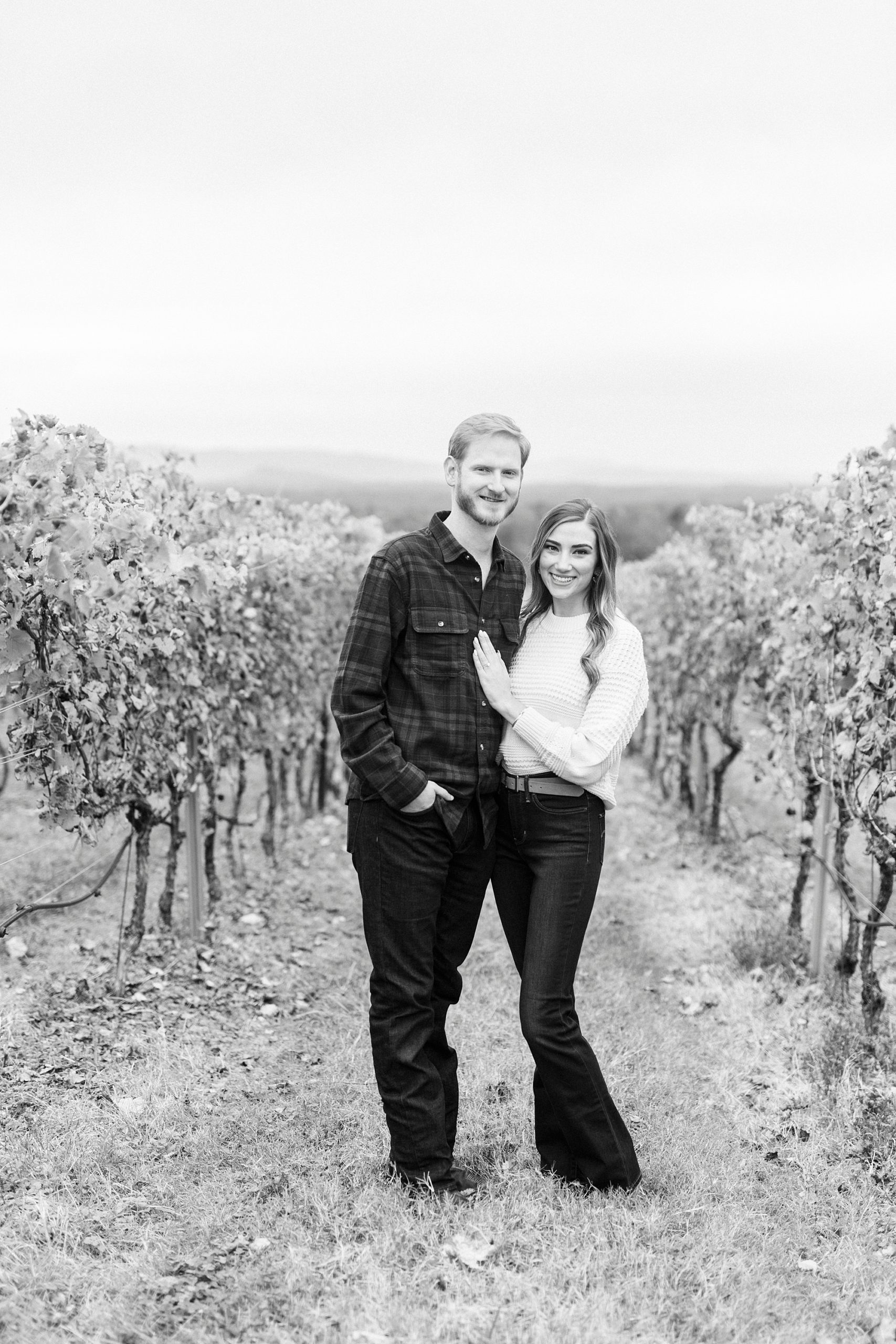 black and white portrait of bride and groom between vines at Raffaldini Vineyards