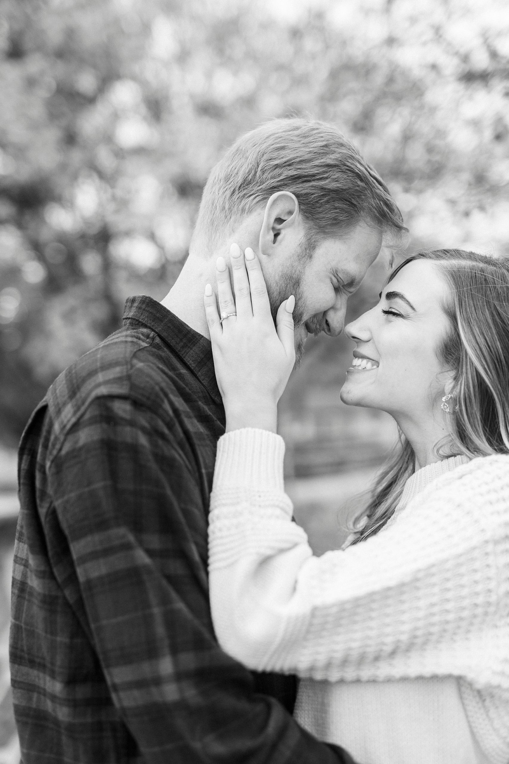 bride holds groom's cheek touching noses together 
