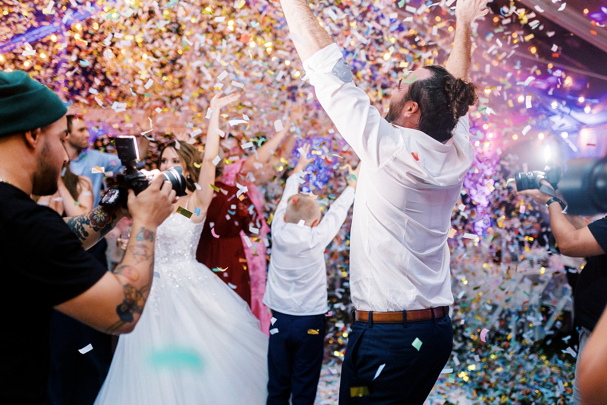 confecting popper on dance floor during wedding reception