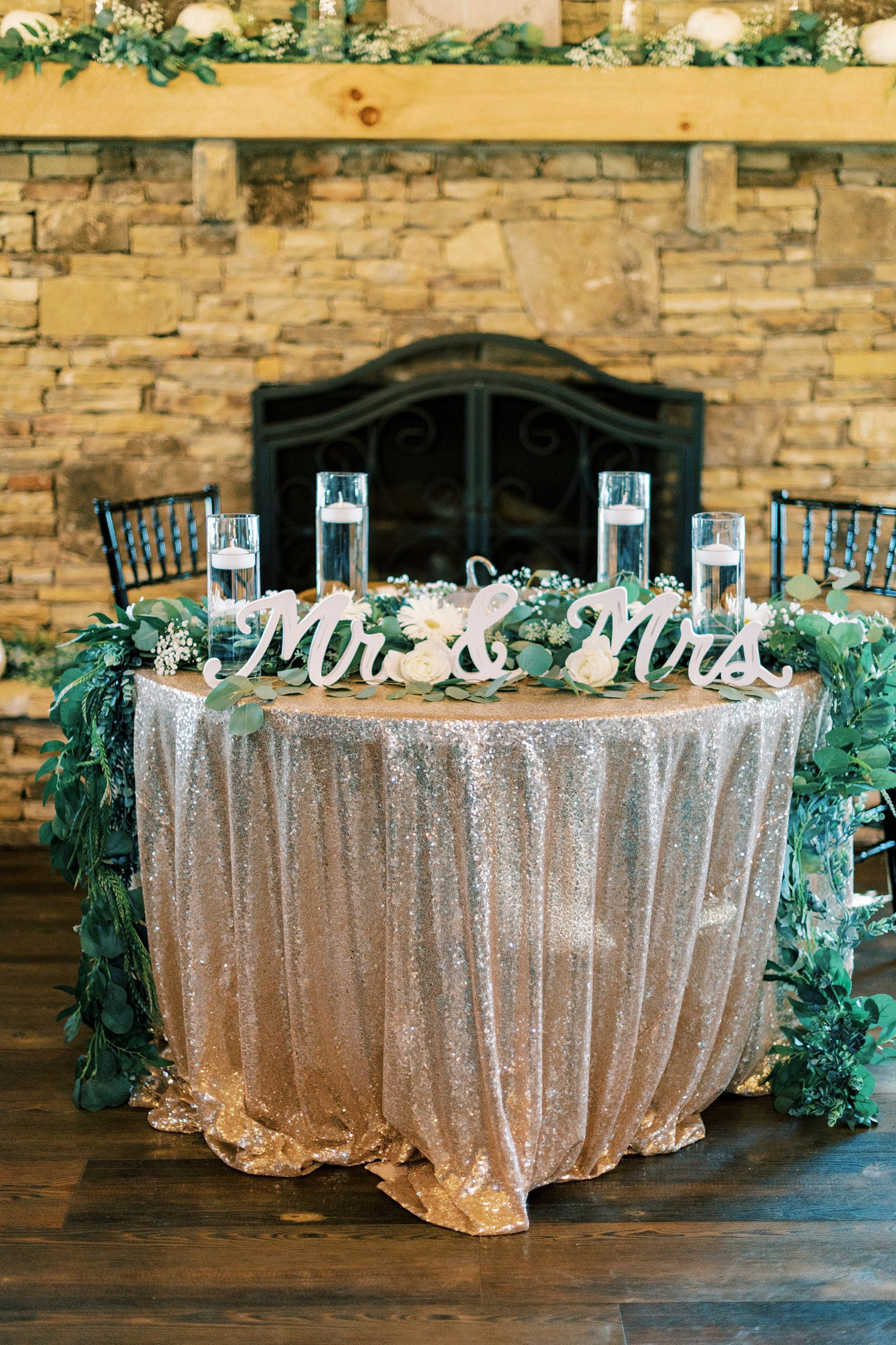 sweetheart table with blush pink tablecloth in front of table cloth 