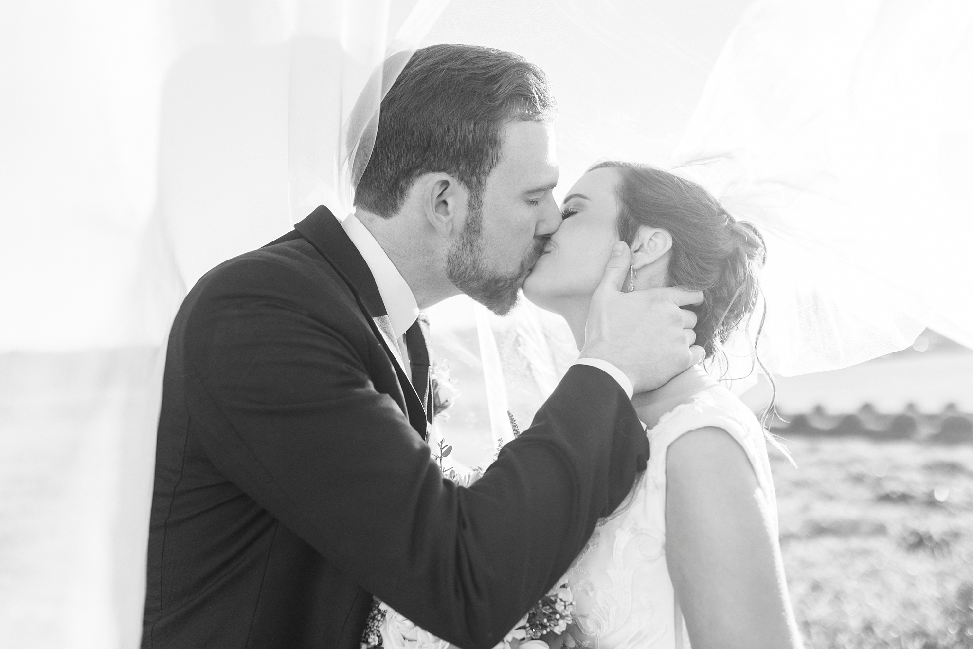 bride and groom kiss under bride's veil 