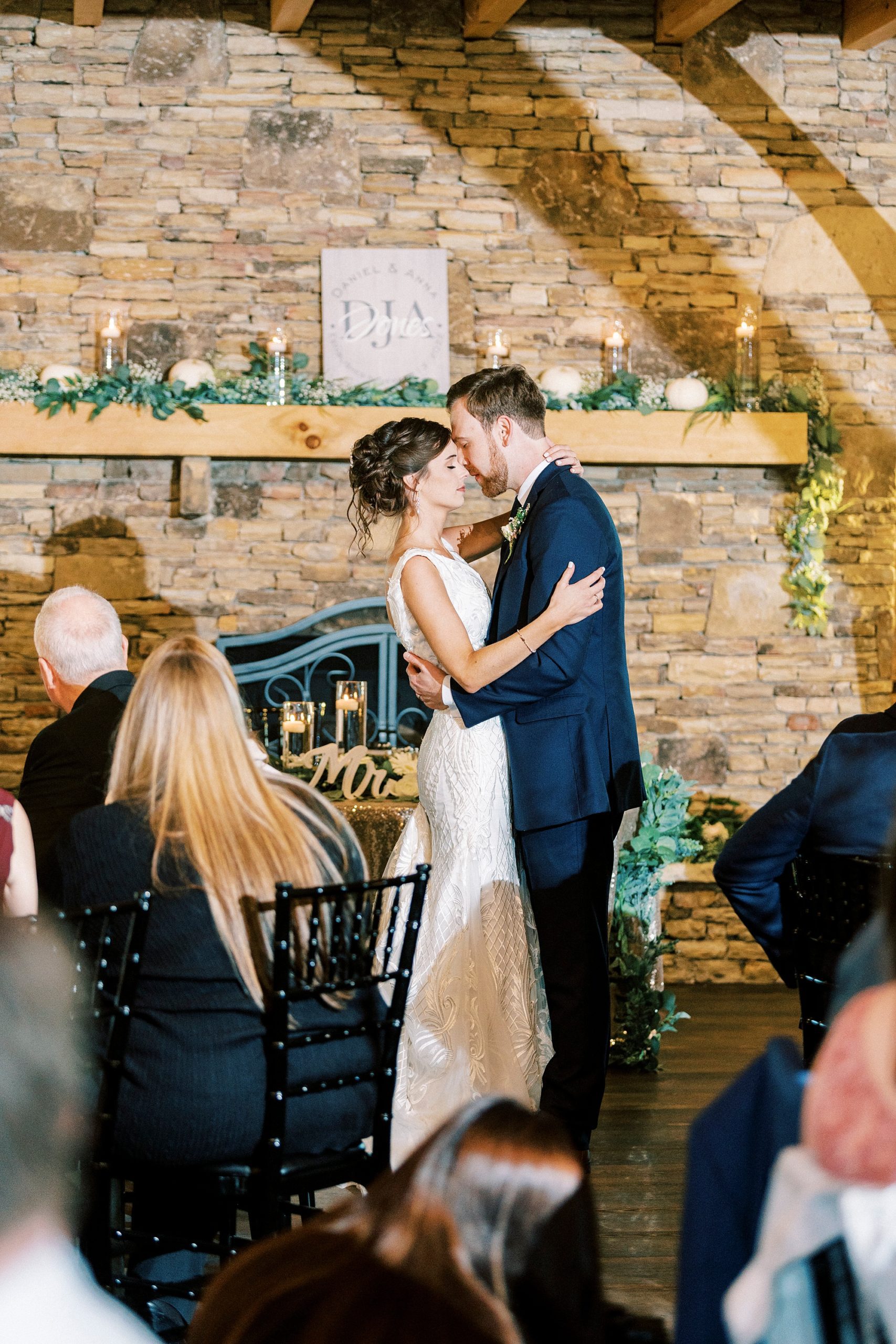 bride and groom hug closely during first dance 
