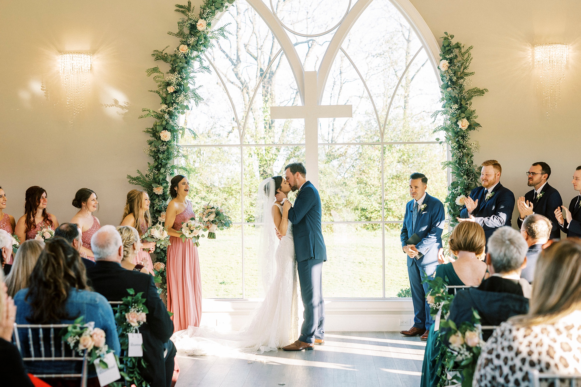newlyweds kiss during ceremony in chapel at Chickadee Hill Farms