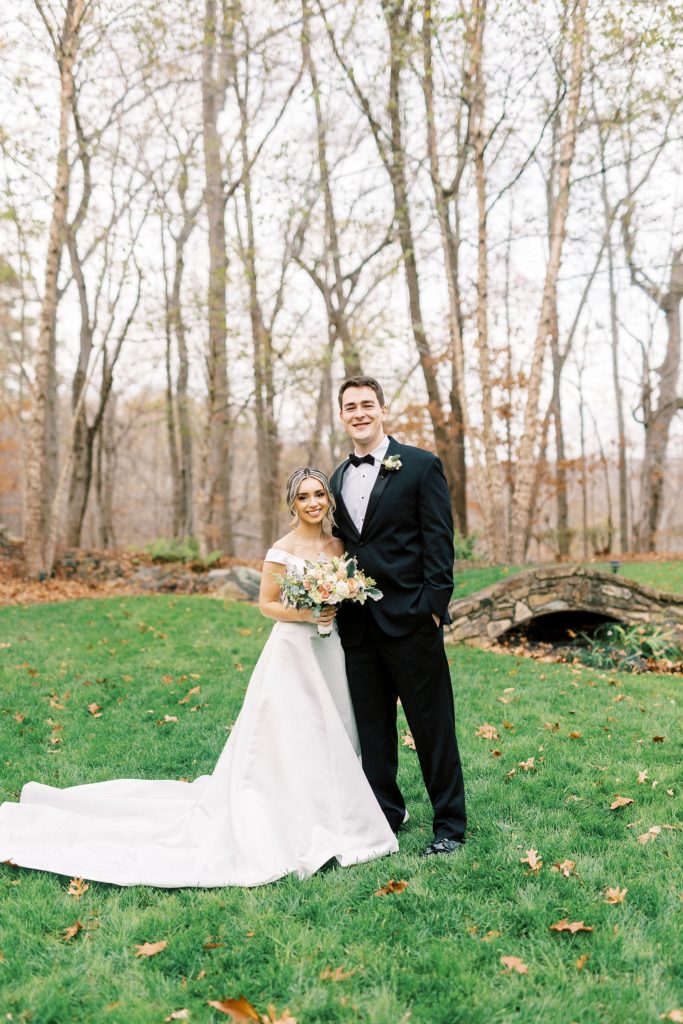 bride and groom stand together on lawn in Concord NC