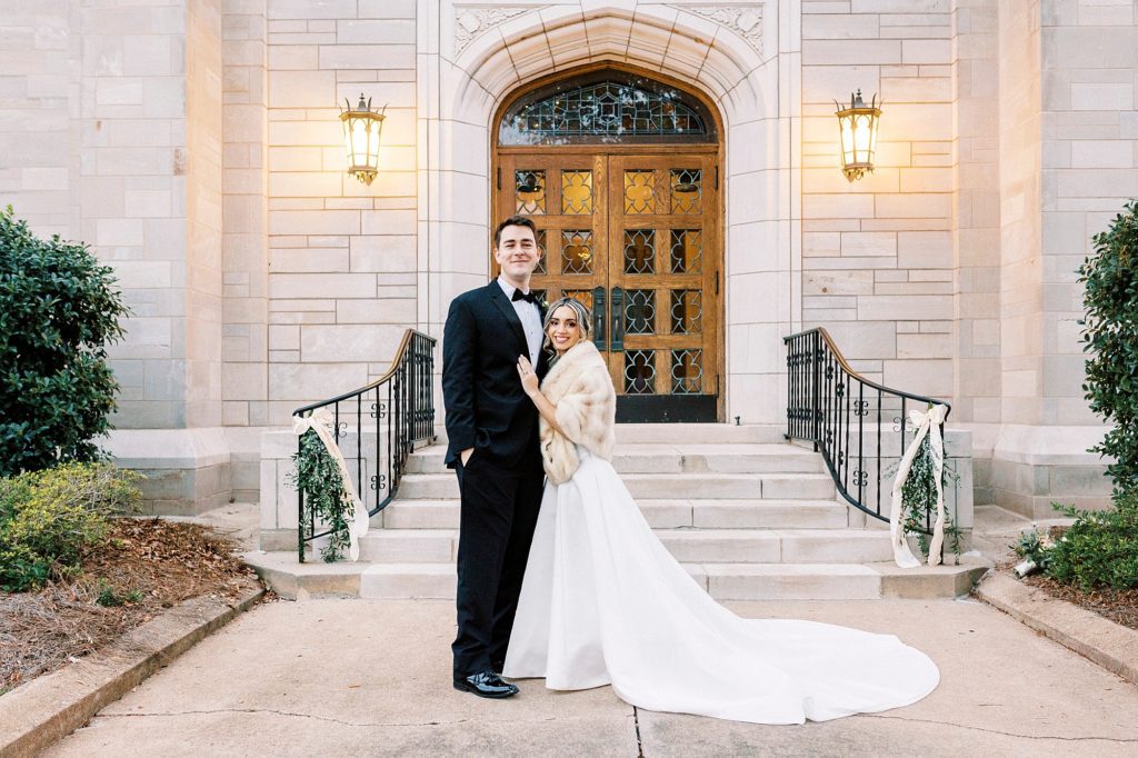 bride and groom stand outside St. James Lutheran Church in Concord NC