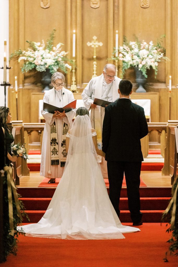 bride and groom stand at alter inside St. James Lutheran Church in Concord NC