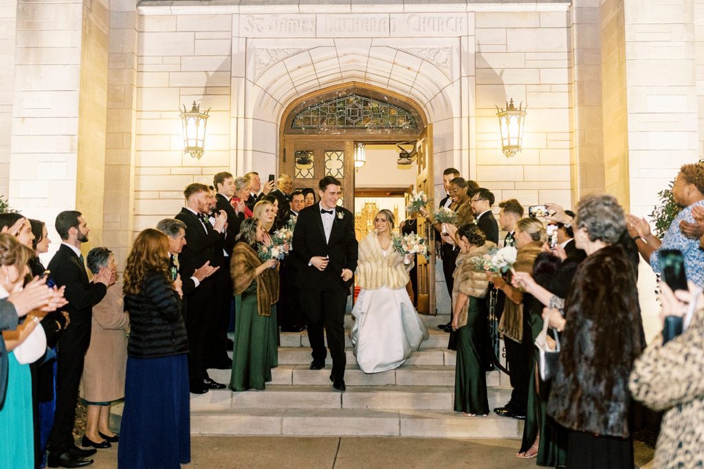 guests cheer for bride and groom leaving St. James Lutheran Church in Concord NC