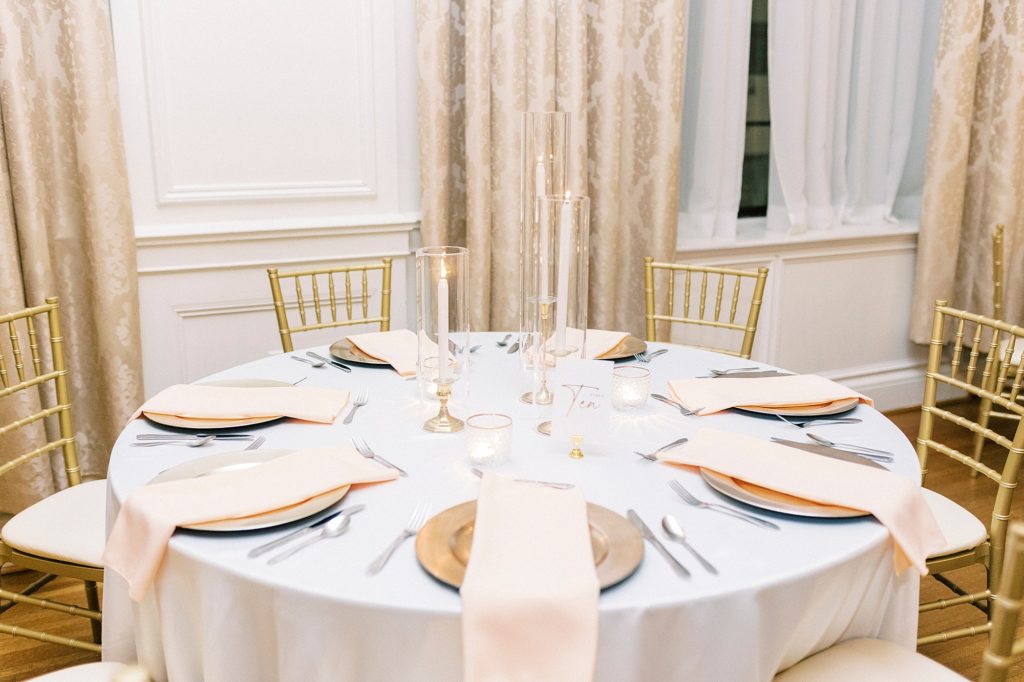 wedding reception table with pale pink napkin
