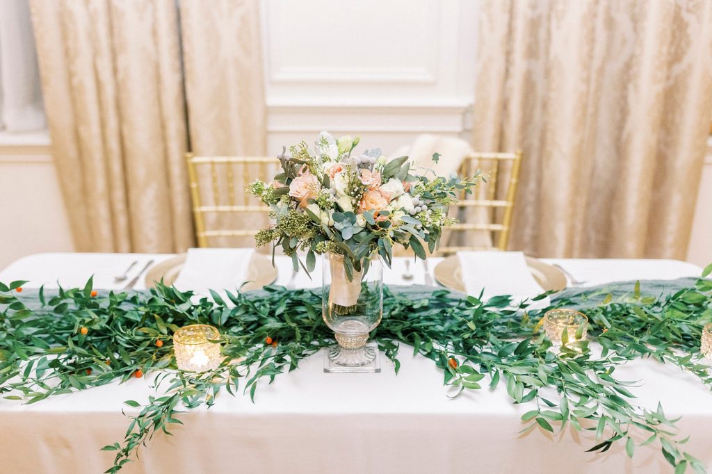 greenery and flowers in center of sweetheart table at the Hotel Concord