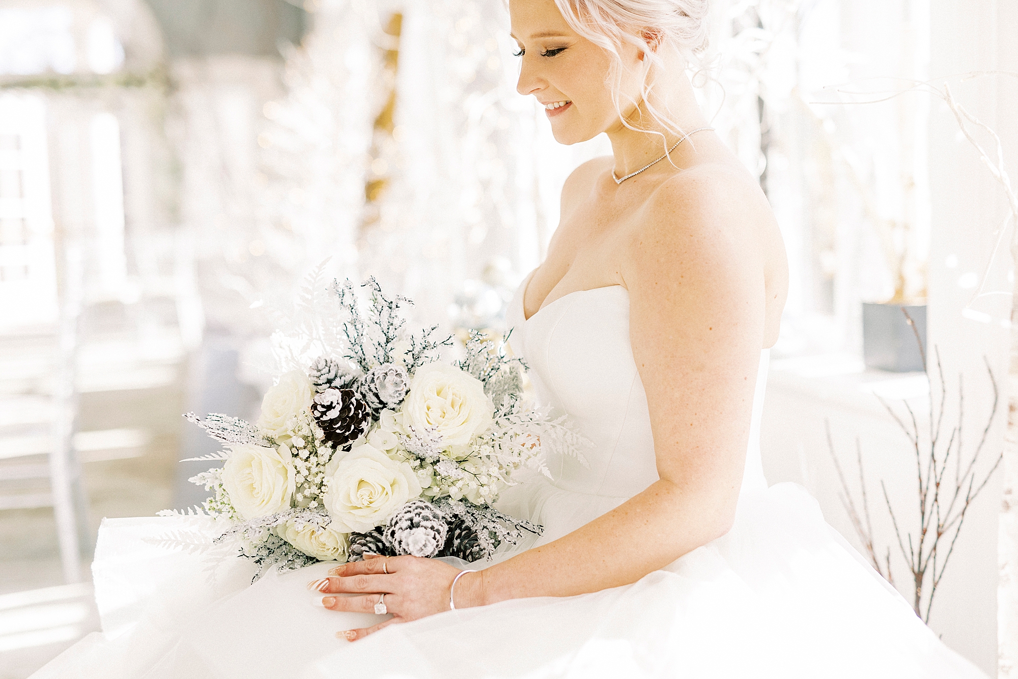 bride sits with winter bouquet in lap
