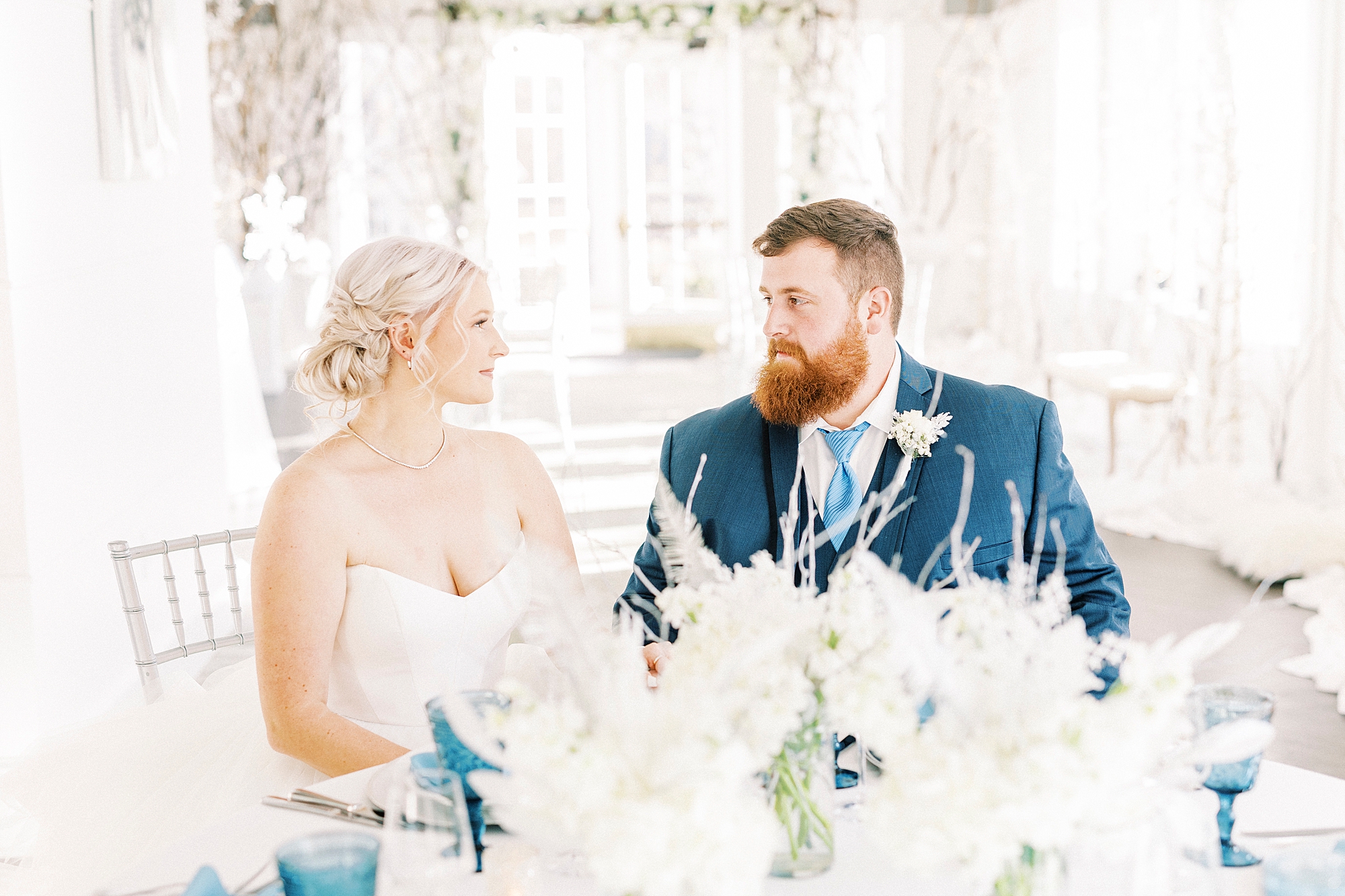 newlyweds sit and talk during reception