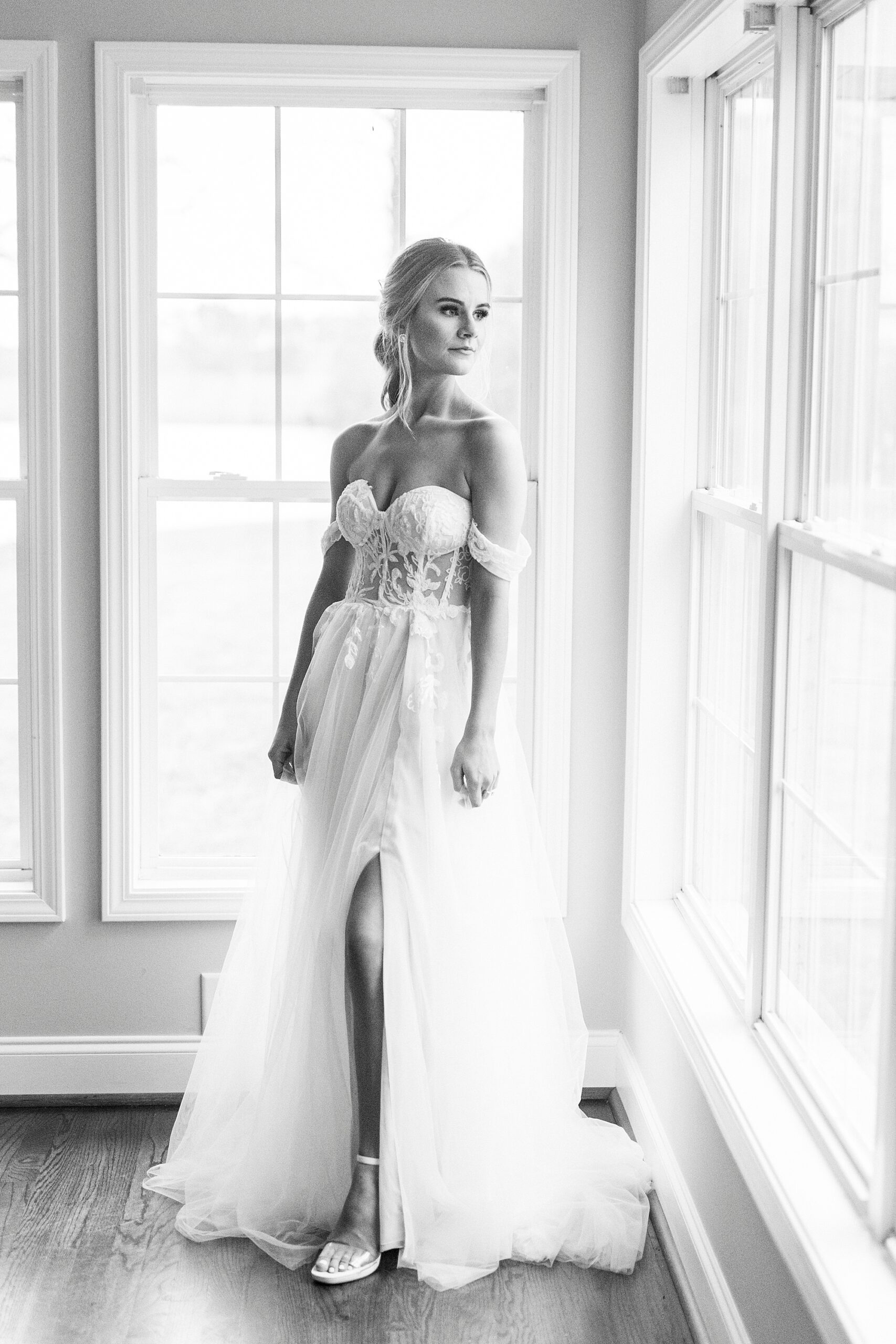 black and white bridal portrait of bride by window at The Farmstead