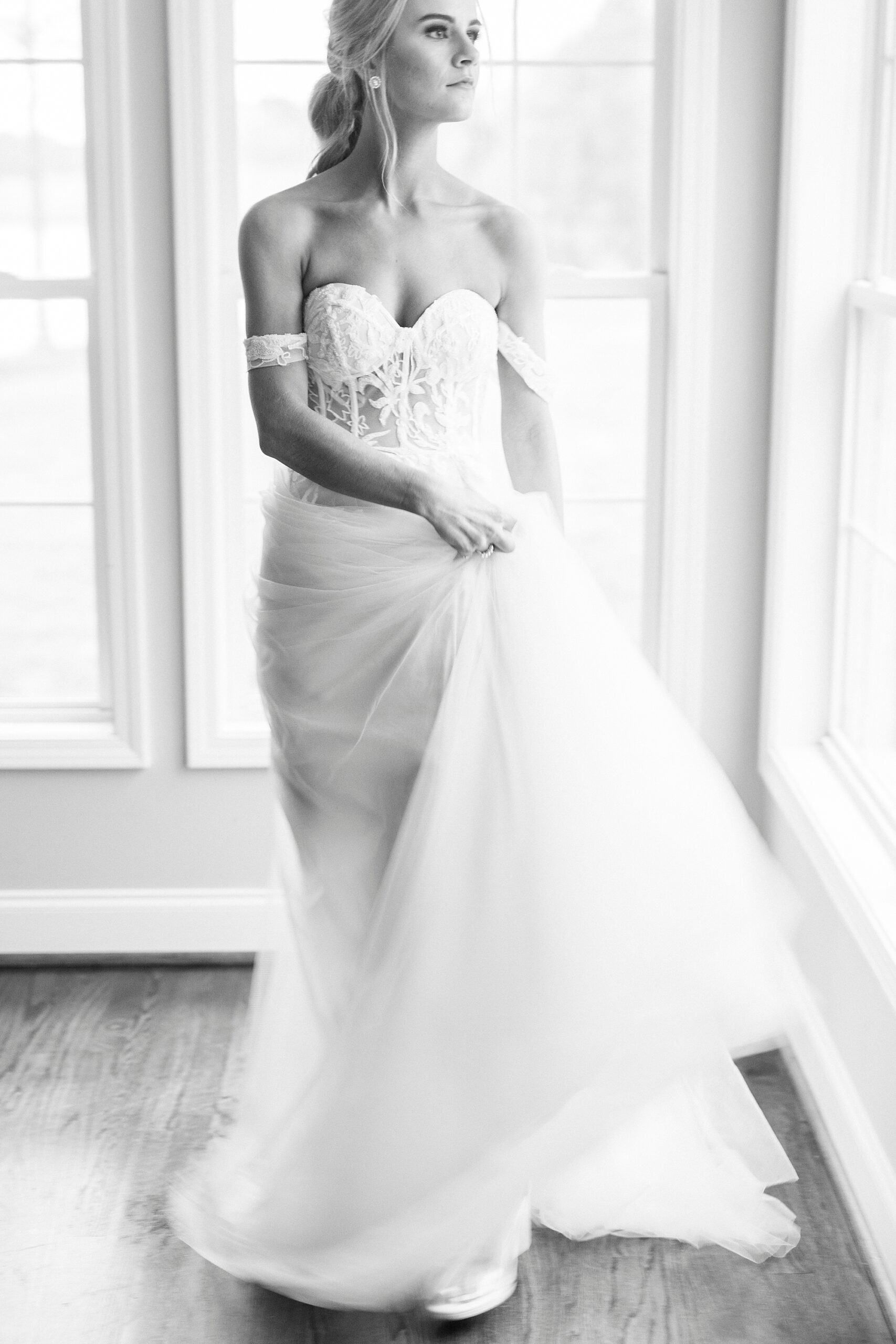 bride twirls with skirt of wedding gown and corset bodice 