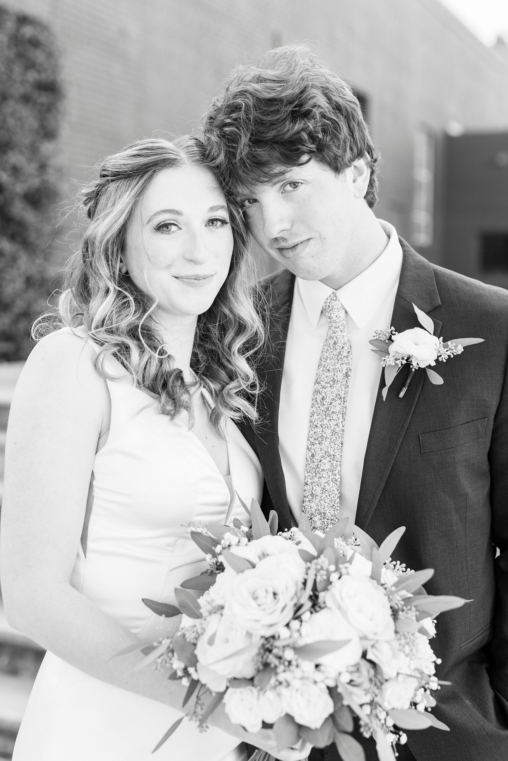black and white portrait of couple in front of Greensboro NC wedding venue 