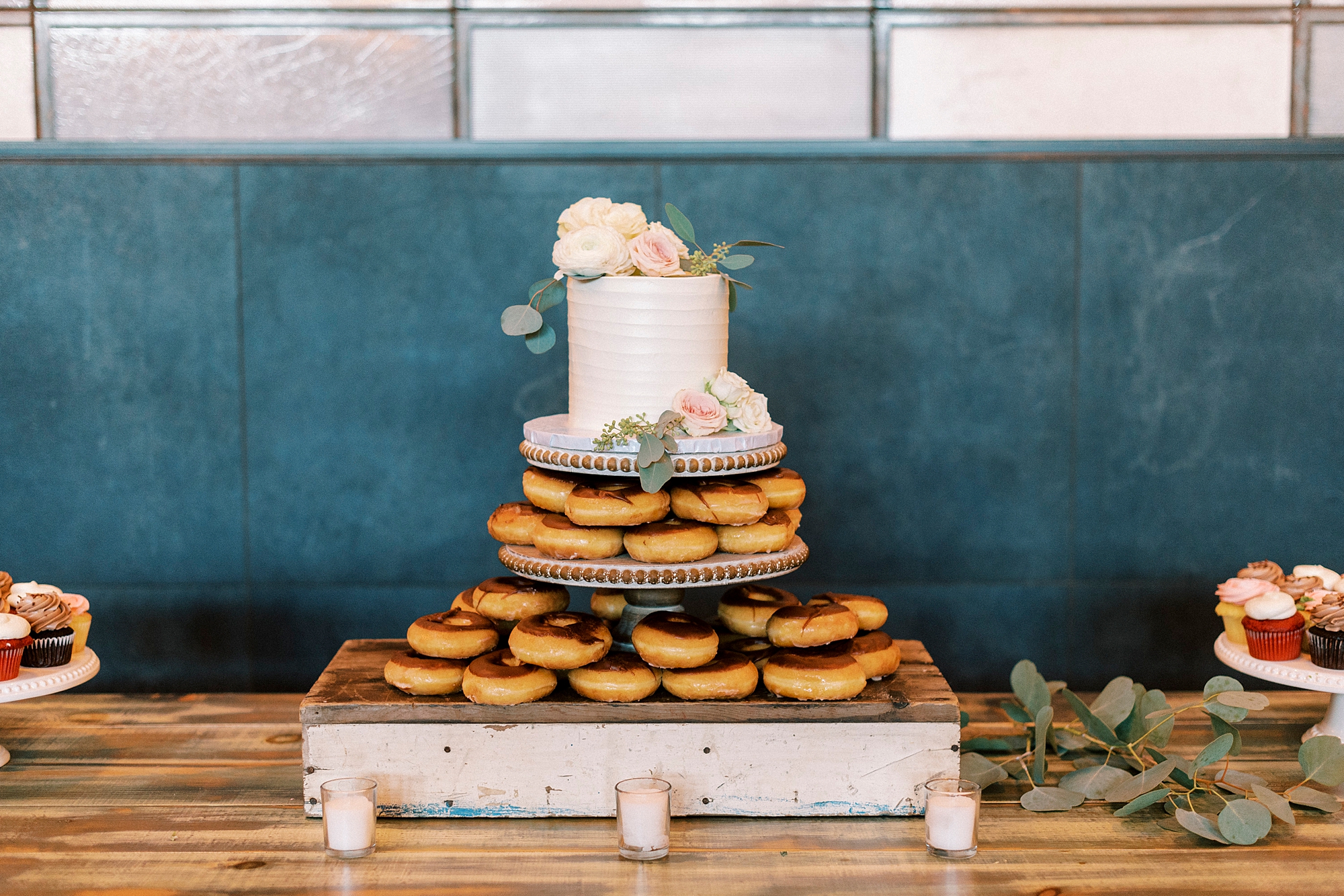 cake sits on top of two tiers of donuts 