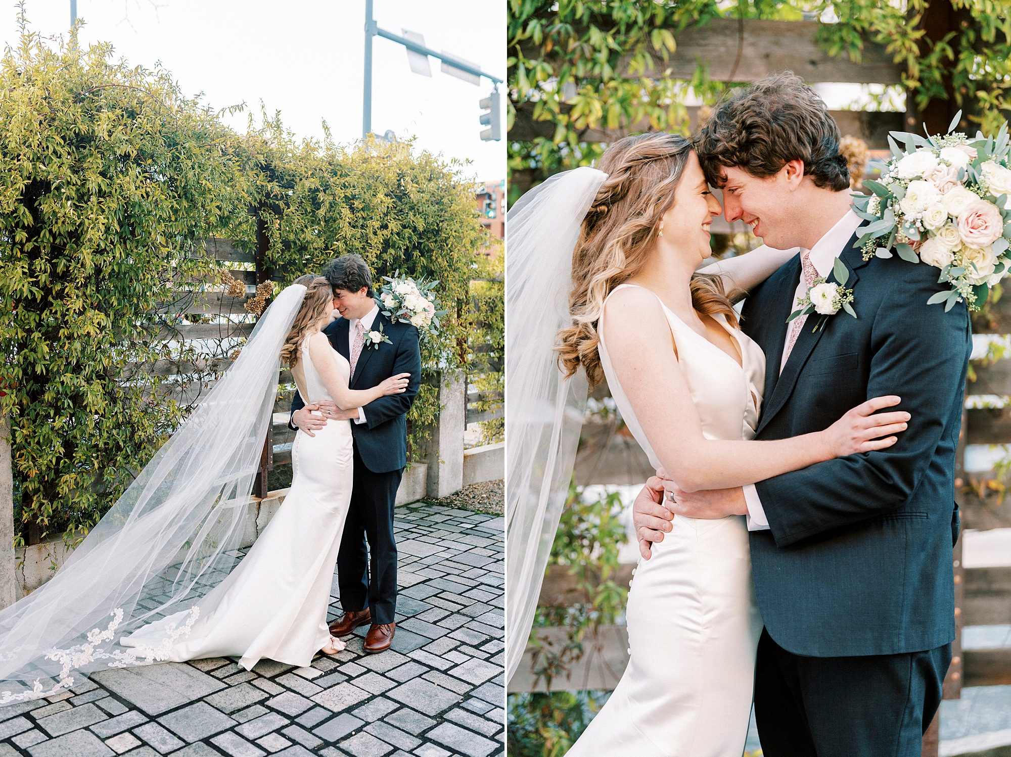 newlyweds hug on patio with greenery wall behind them 