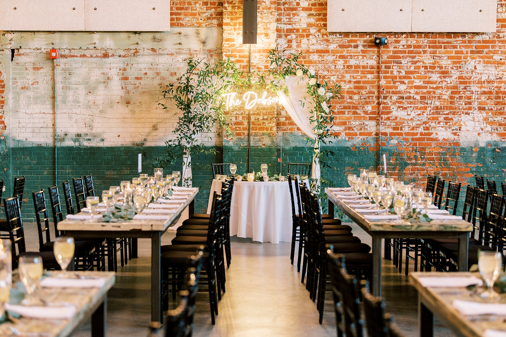 family style seating for industrial inspired wedding reception at the Cadillac Service Garage